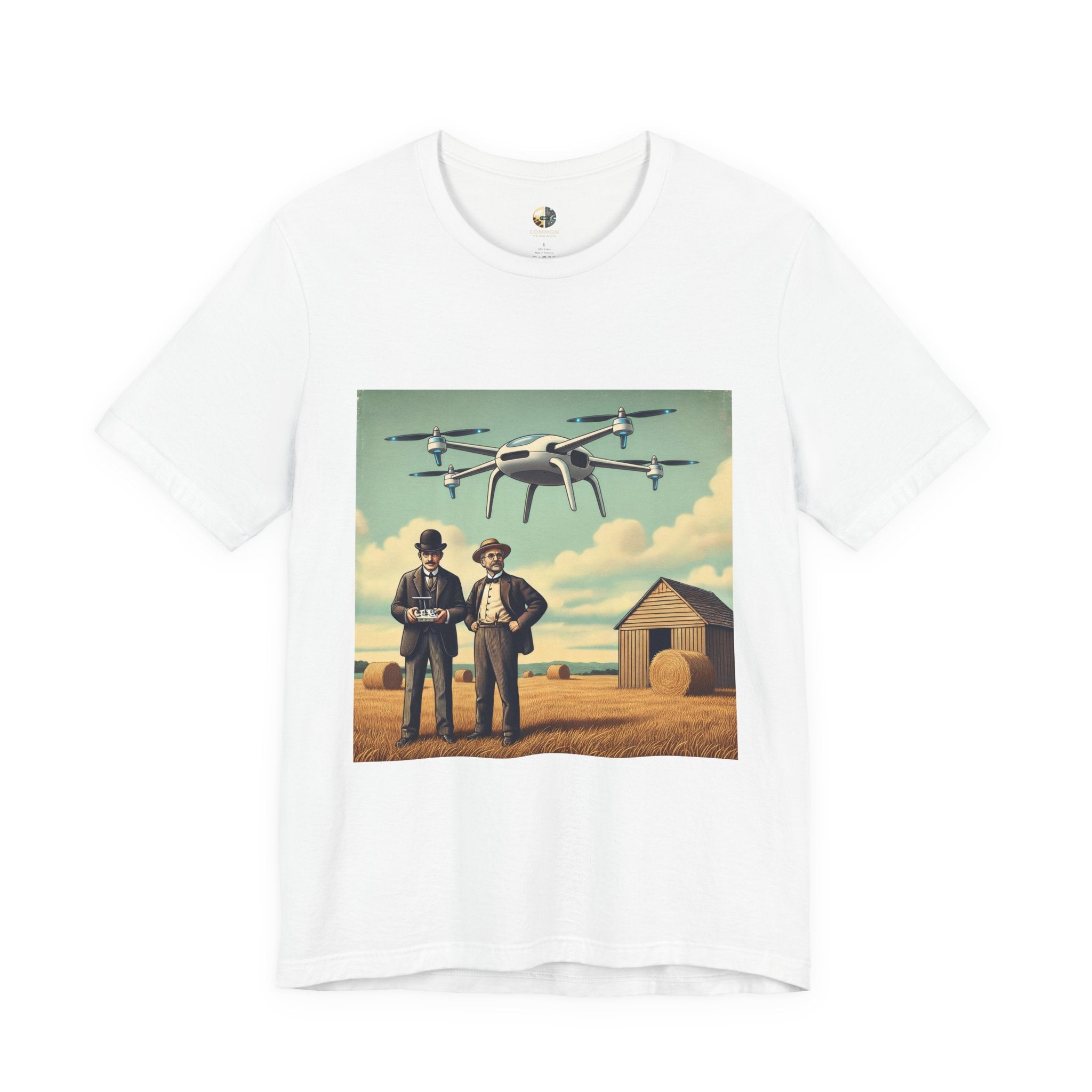 White T-shirt featuring a graphic of the Wright brothers standing in a hayfield operating a modern quadcopter drone