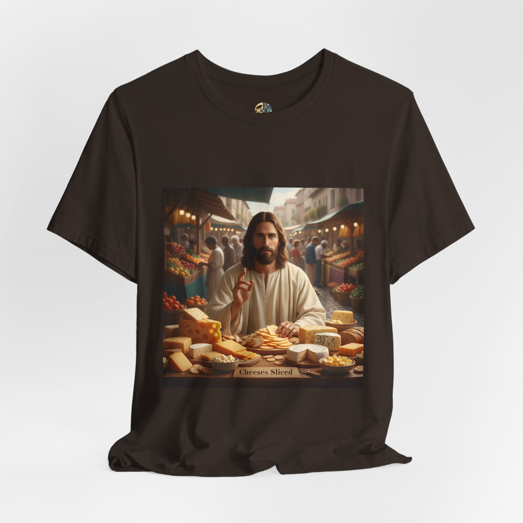 Brown T-shirt featuring a graphic of Jesus in traditional robes at an ancient marketplace selling assorted cheeses, with a sign reading ‘Cheeses Sliced‘