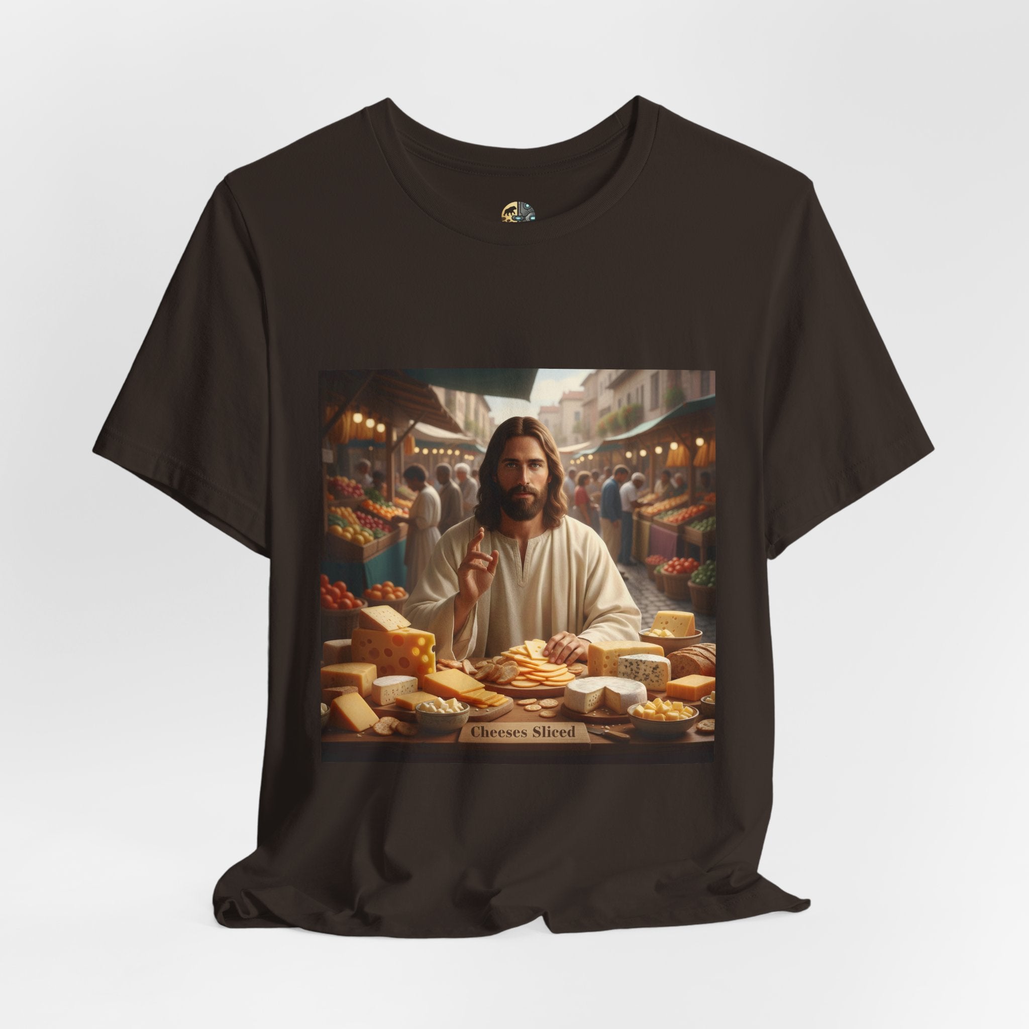 Brown T-shirt featuring a graphic of Jesus in traditional robes at an ancient marketplace selling assorted cheeses, with a sign reading ‘Cheeses Sliced‘