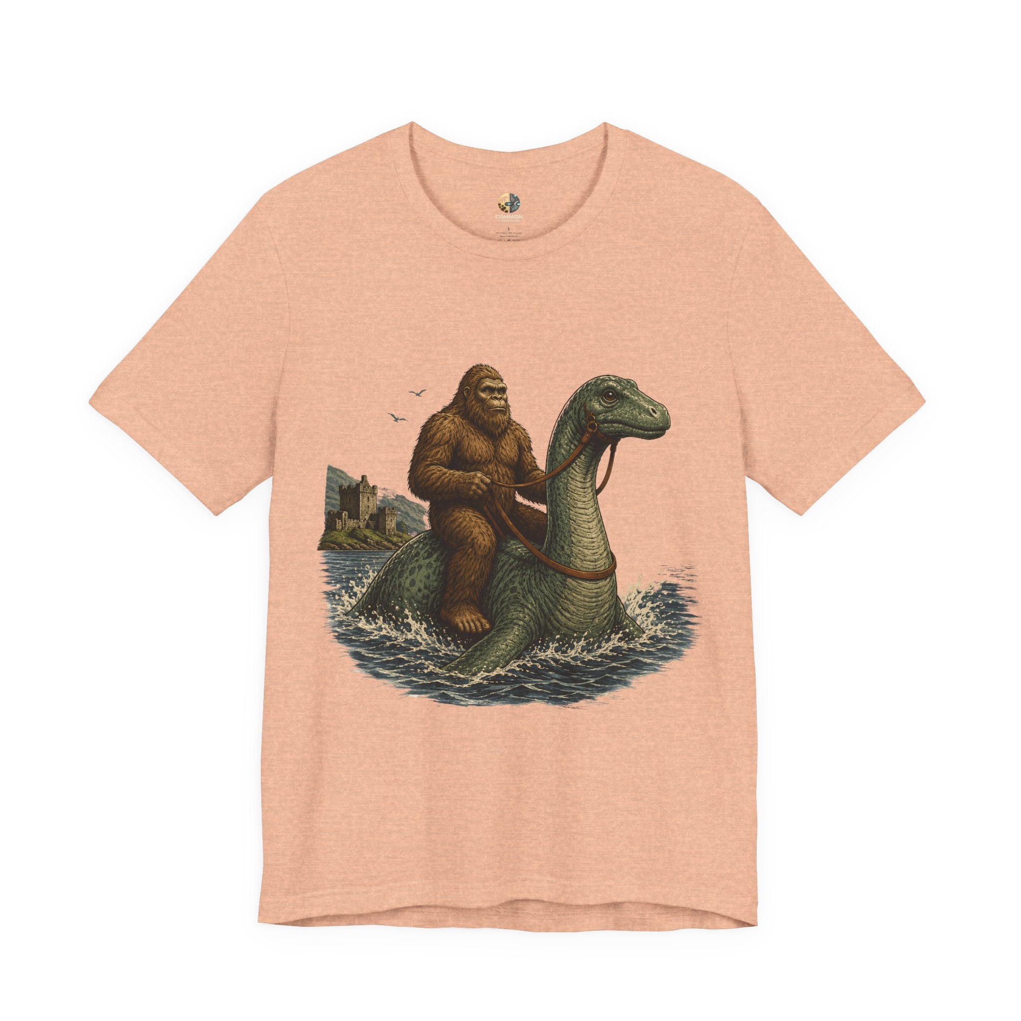 heather peach t-shirt featuring bigfoot riding on the Loch Ness monster