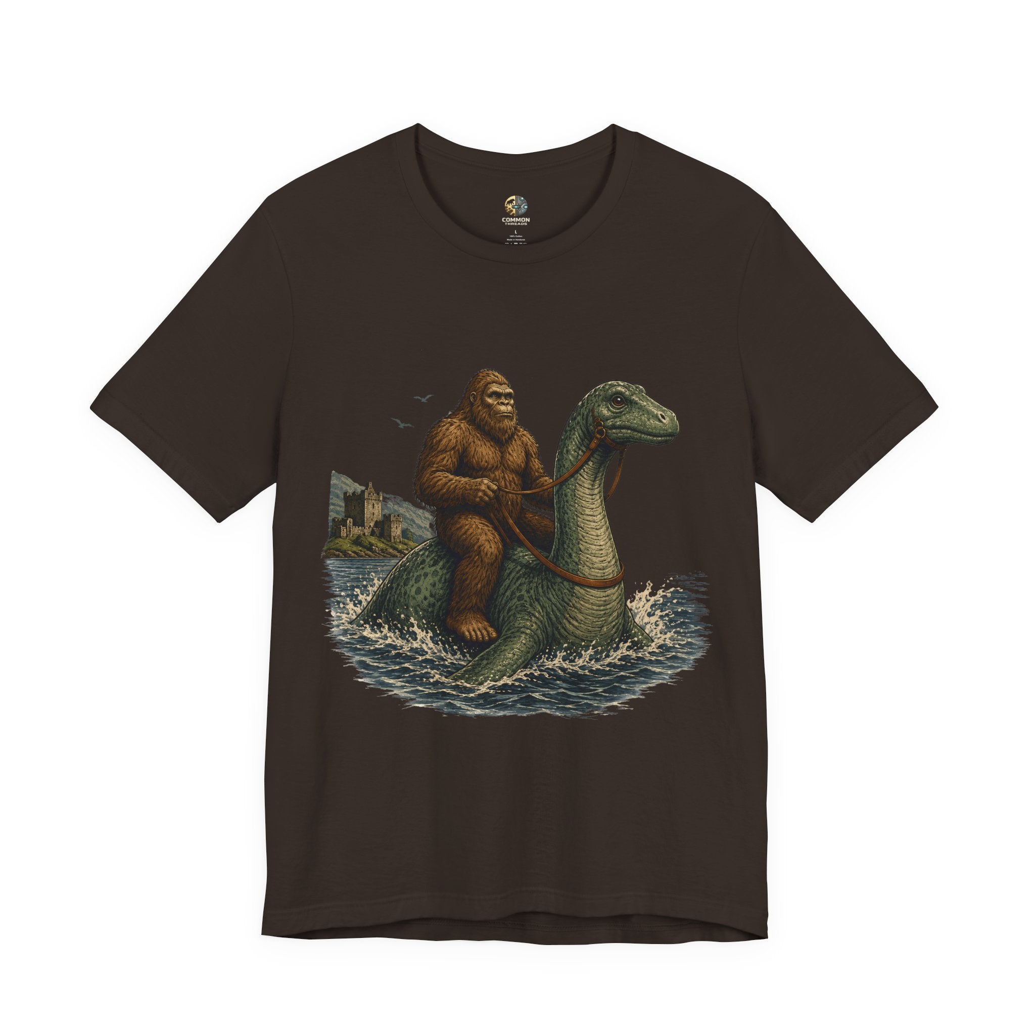 Brown t-shirt featuring bigfoot riding on the Loch Ness monster