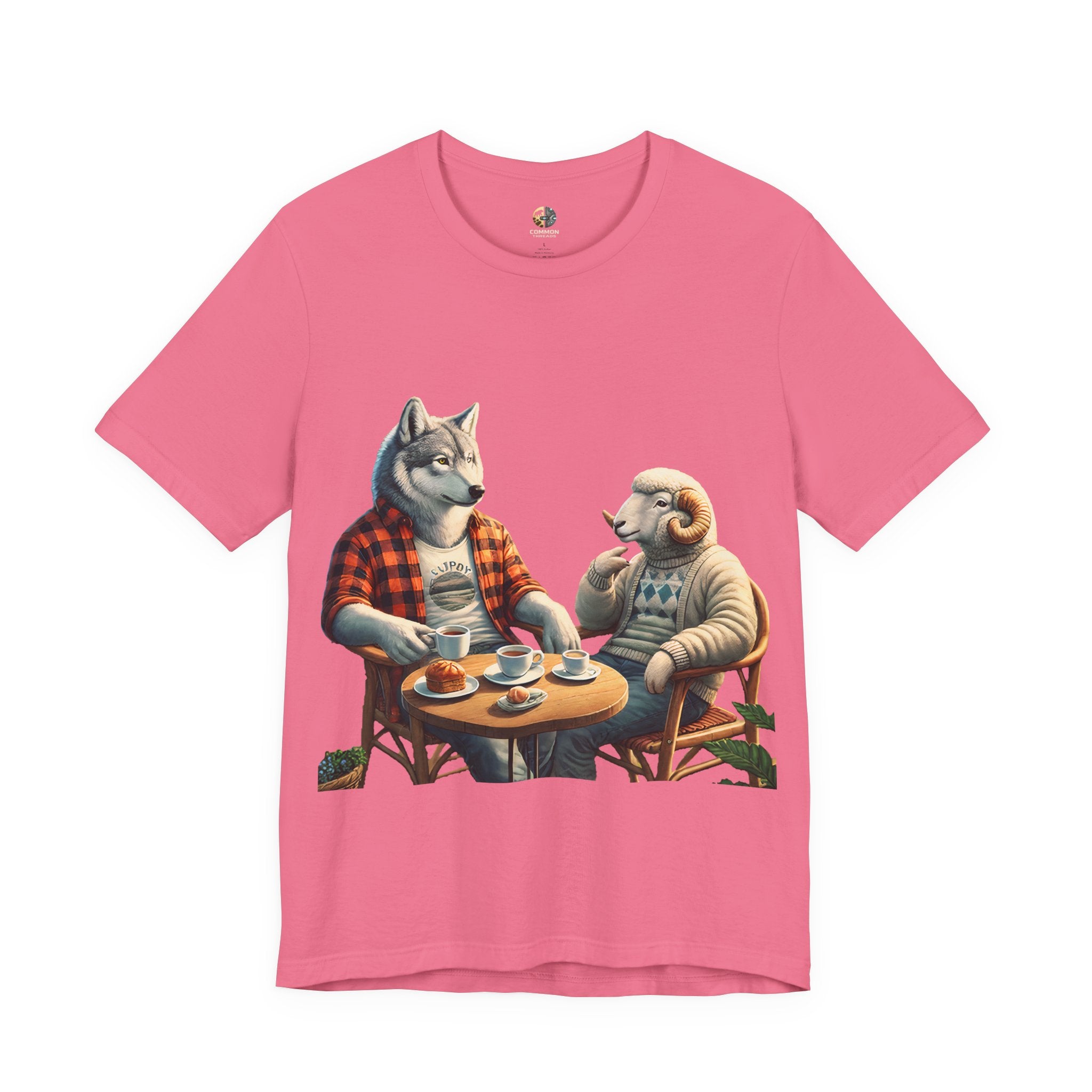 Charity pink T-shirt featuring an anthropomorphic wolf in a flannel shirt and a ram in a patterned sweater sitting at a café table with coffee