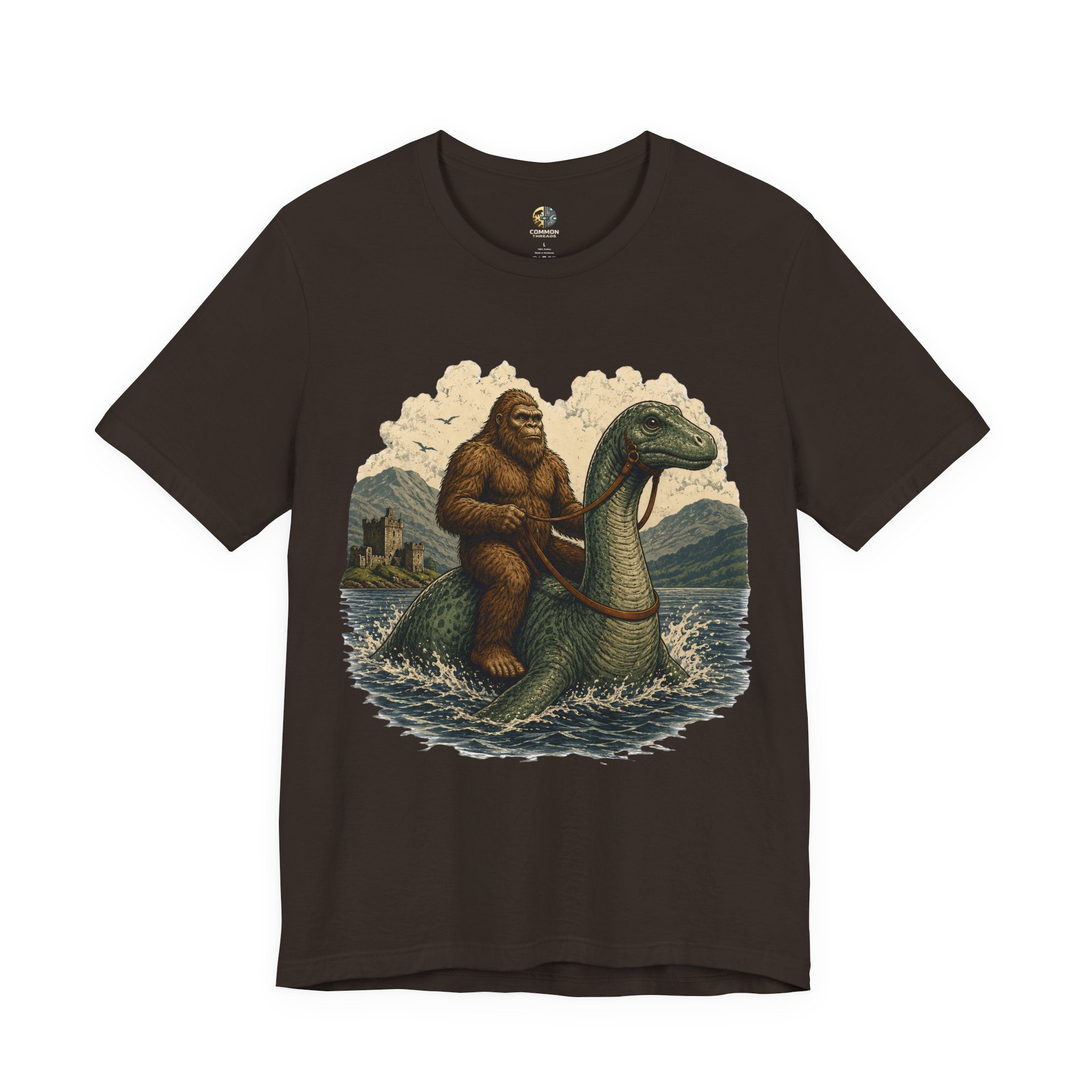 Brown t-shirt featuring bigfoot riding on the Loch Ness monster