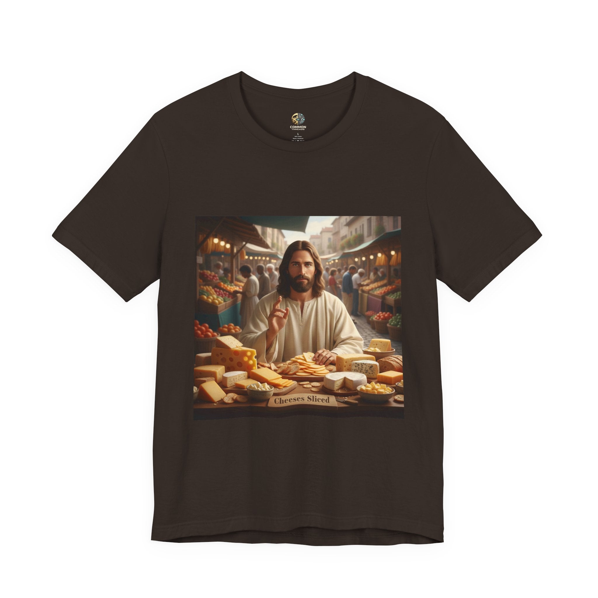 Brown T-shirt featuring a graphic of Jesus in traditional robes at an ancient marketplace selling assorted cheeses, with a sign reading ‘Cheeses Sliced‘