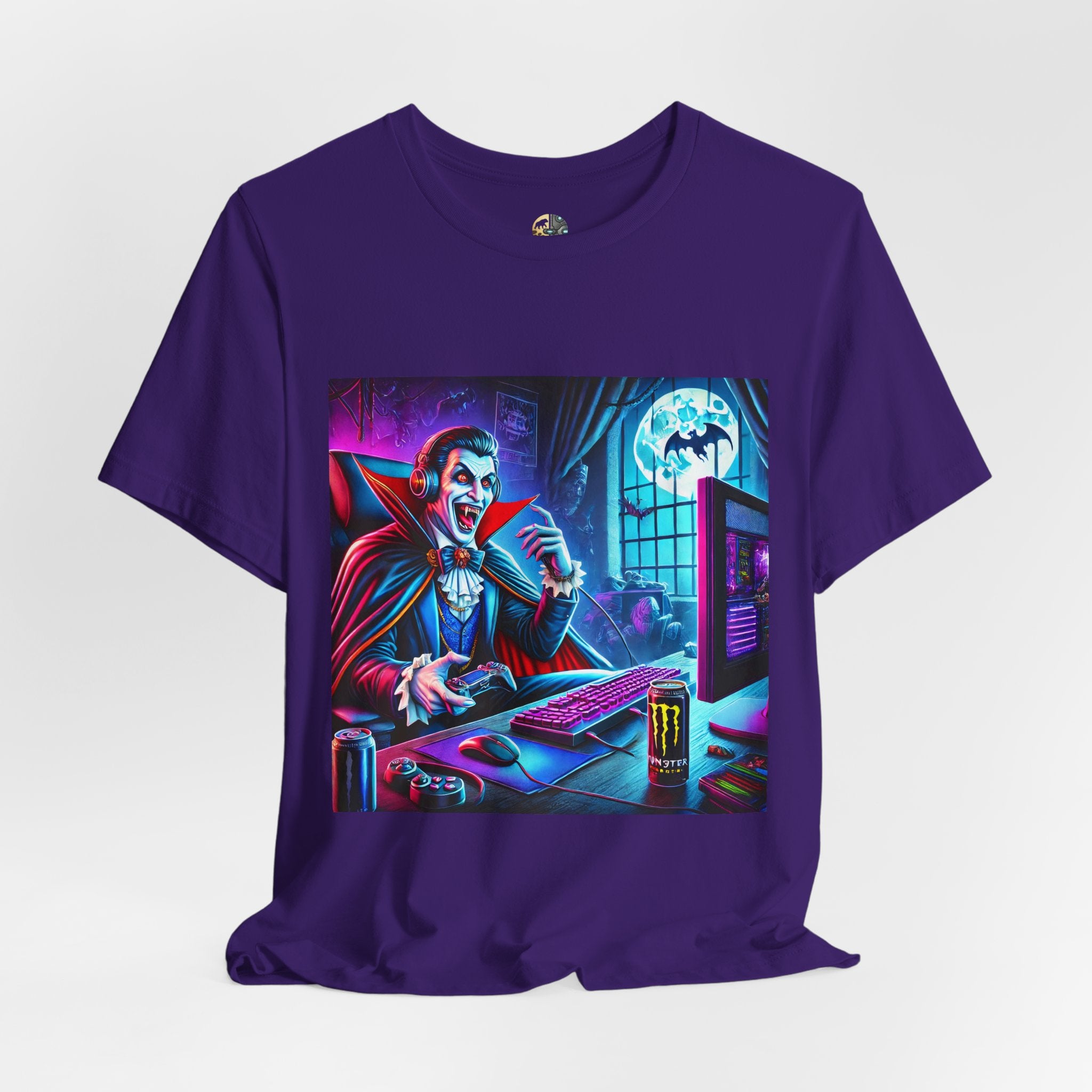 Purple T-shirt graphic of a classic vampire wearing a gaming headset and holding a controller at a neon-lit gaming setup under a full moon