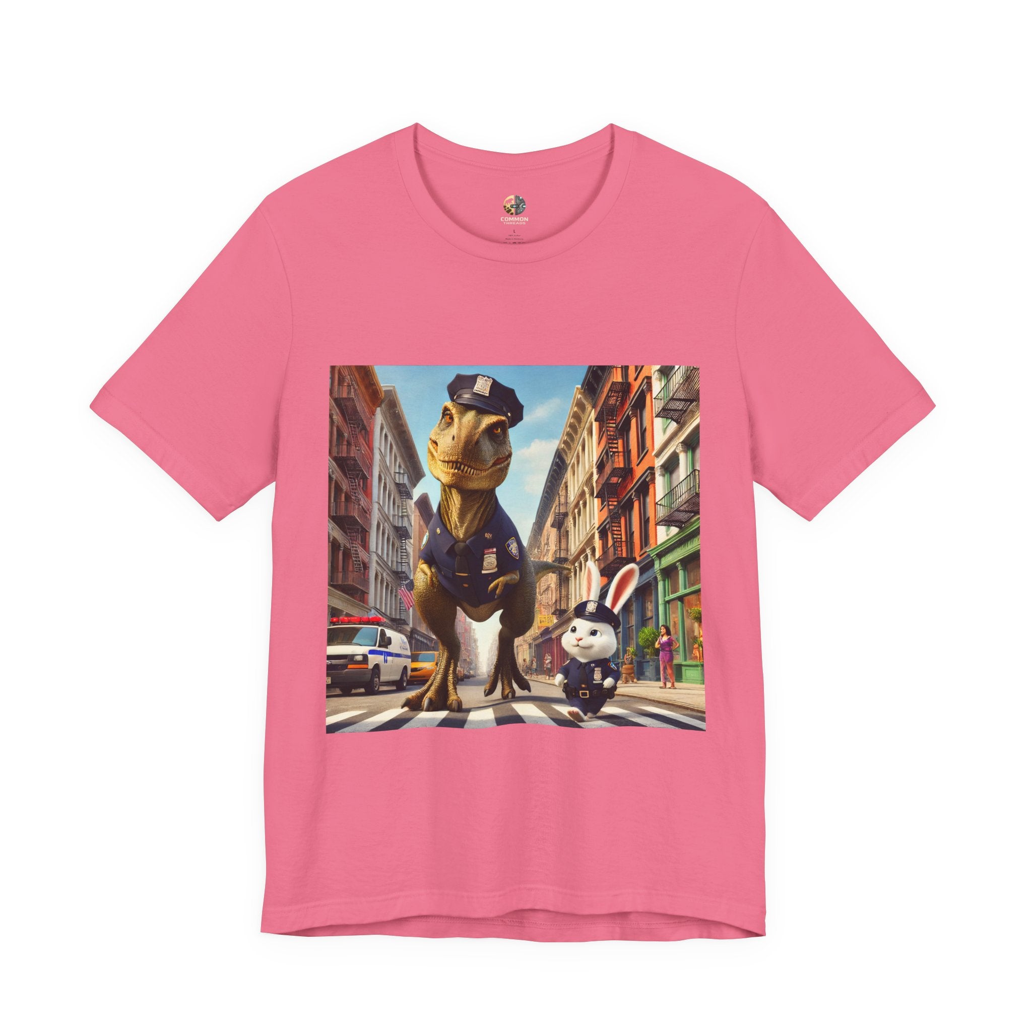 Charity pink T-shirt showing a T-Rex and a bunny dressed as police officers standing together on a crosswalk in a New York–style urban setting