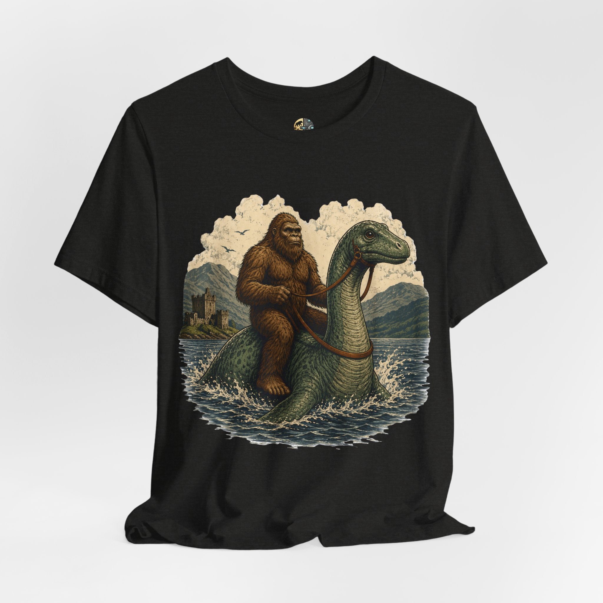 Black heather t-shirt featuring bigfoot riding on the Loch Ness monster