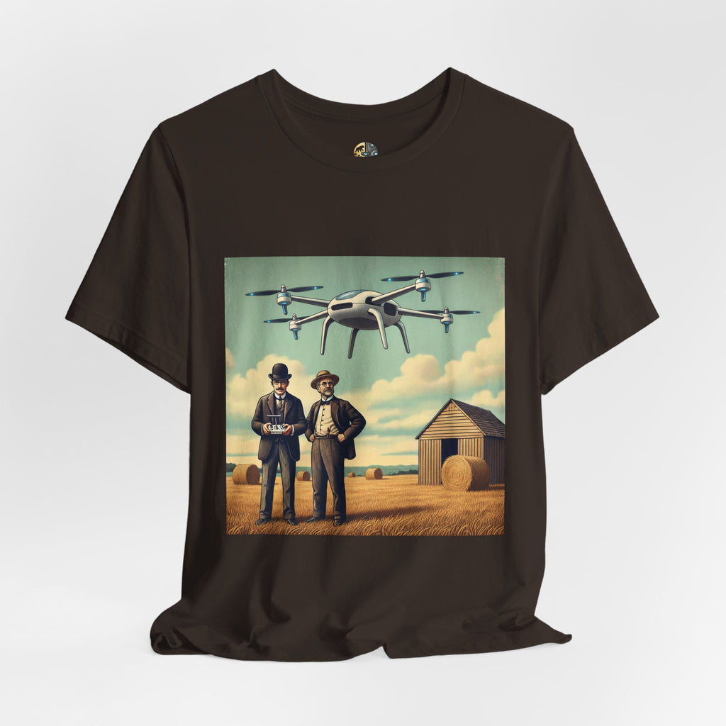 Brown T-shirt featuring a graphic of the Wright brothers standing in a hayfield operating a modern quadcopter drone