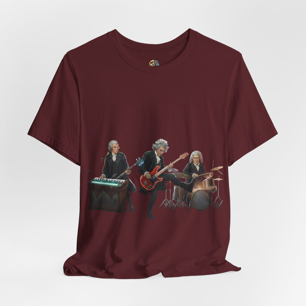 Maroon color t-shirt featuring Mozart on bass and keyboard, Beethoven on electric guitar, and Bach on drums in a rock band scene