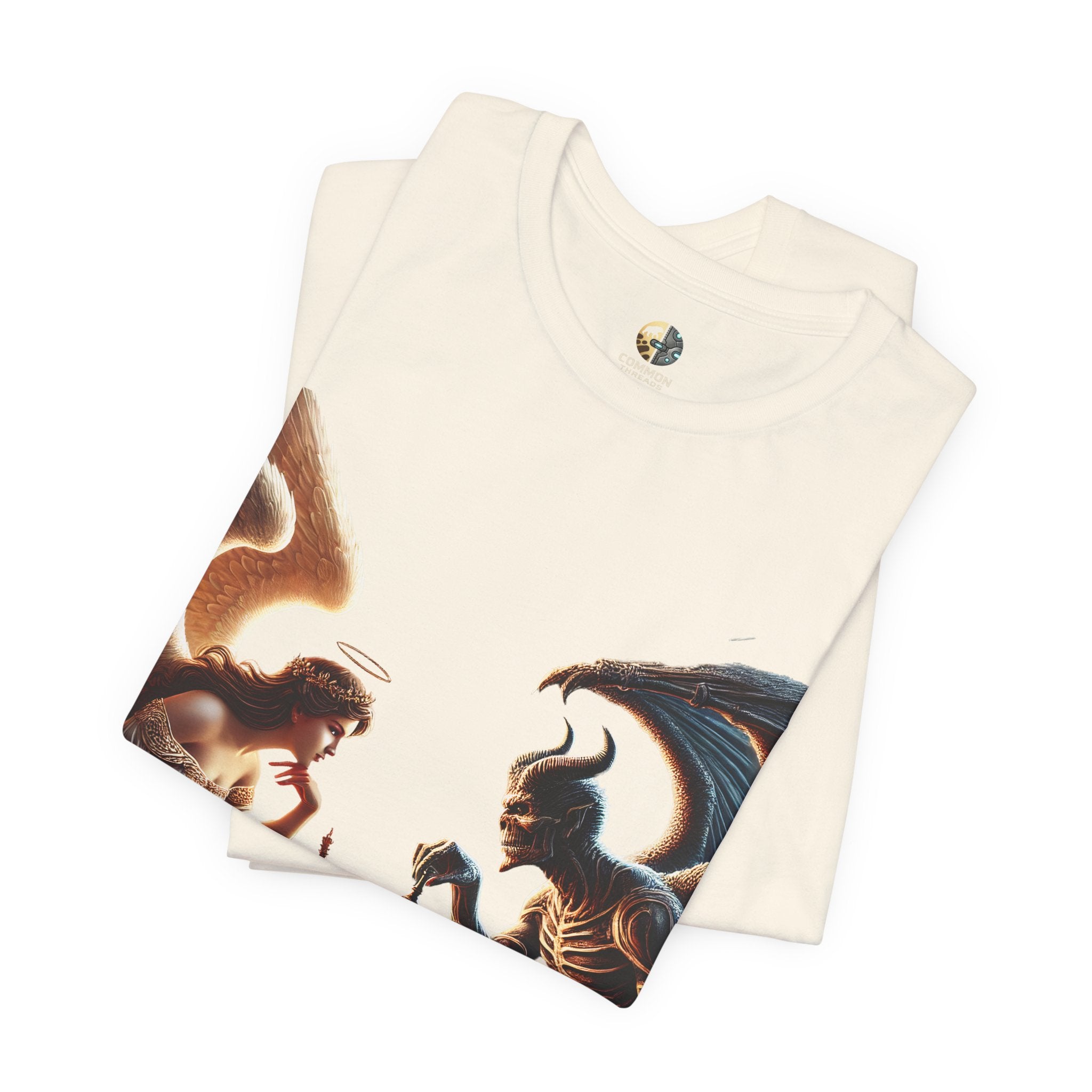 Folded natural color T-shirt featuring a graphic of an angel and a demon playing chess, with a golden king piece levitating