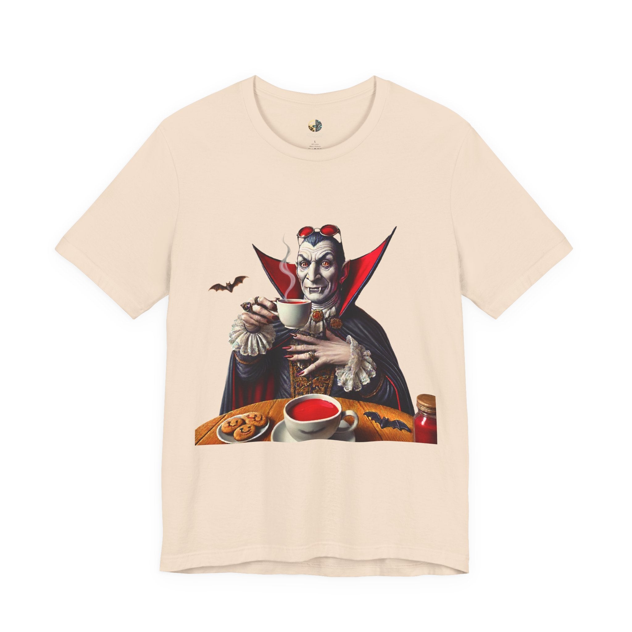 Soft creme T-shirt featuring a classic vampire dressed like Count Dracula sitting in a café, wearing red sunglasses and drinking from a teacup filled with red liquid