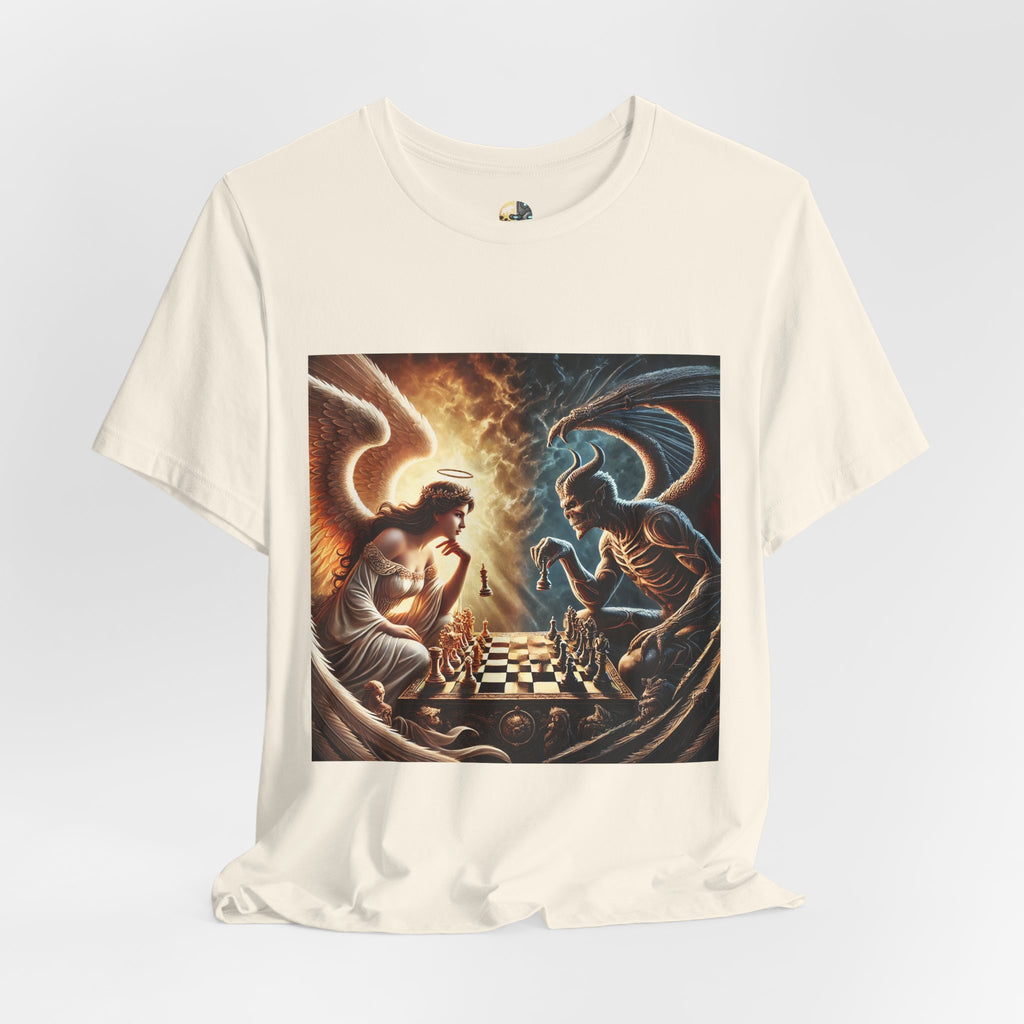 Natural color T-shirt featuring a graphic of an angel and a demon playing chess, with a golden king piece levitating, a dark background behind the demon and warm light tones behind the angel