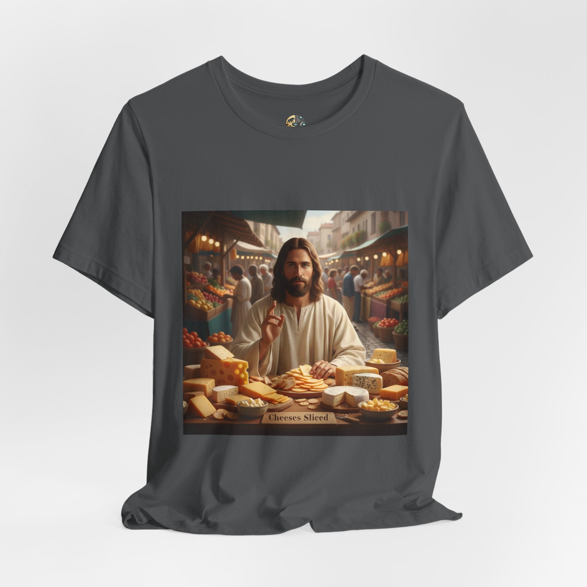 Asphalt grey T-shirt featuring a graphic of Jesus in traditional robes at an ancient marketplace selling assorted cheeses, with a sign reading ‘Cheeses Sliced‘
