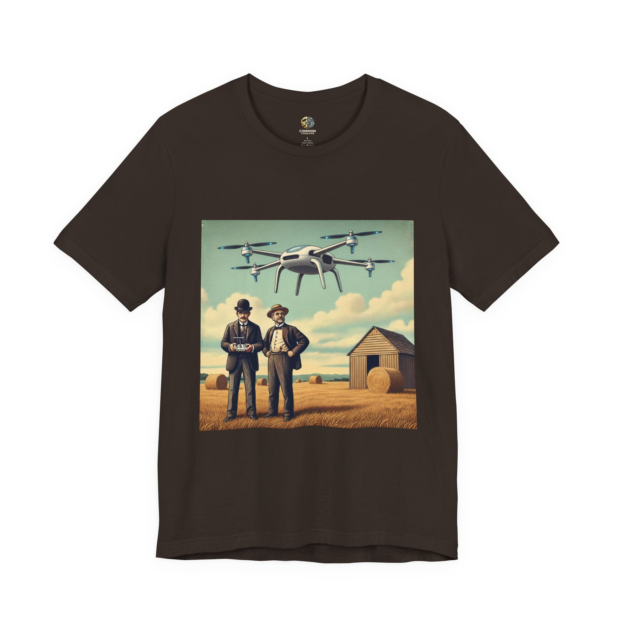 Brown T-shirt featuring a graphic of the Wright brothers standing in a hayfield operating a modern quadcopter drone