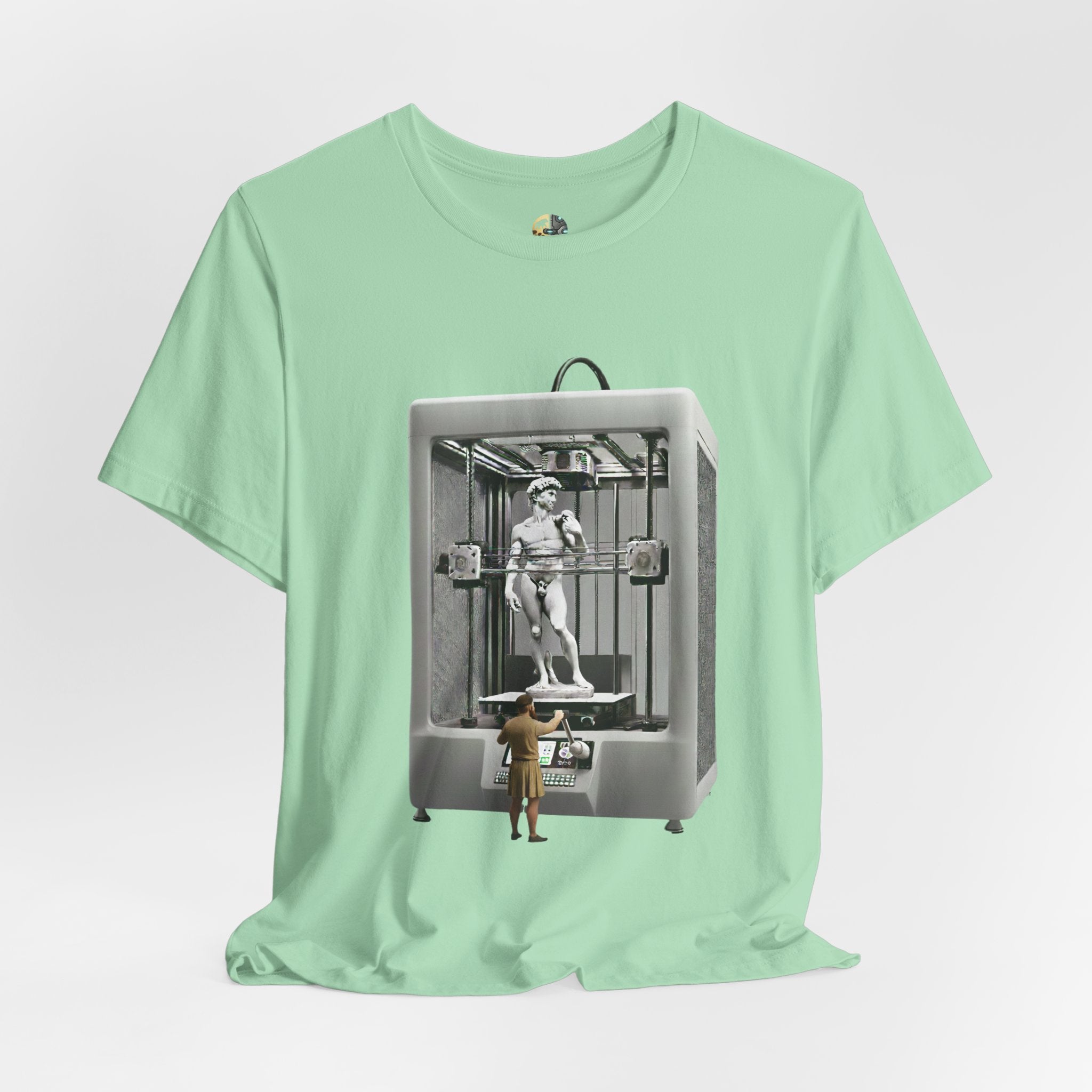 Mint green T-shirt featuring a graphic of Michelangelo’s David statue being created inside a large 3D printer, with Michelangelo standing at the controls
