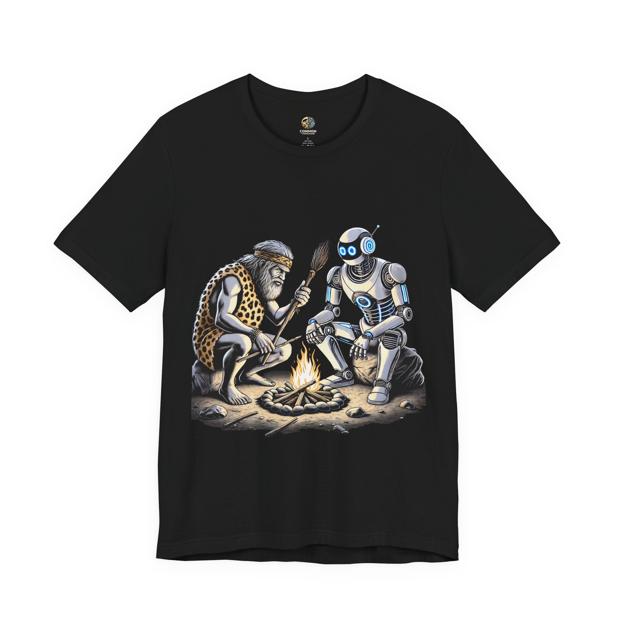Black T-shirt featuring a graphic of a bearded caveman in a leopard-print pelt sitting by a campfire with a futuristic robot