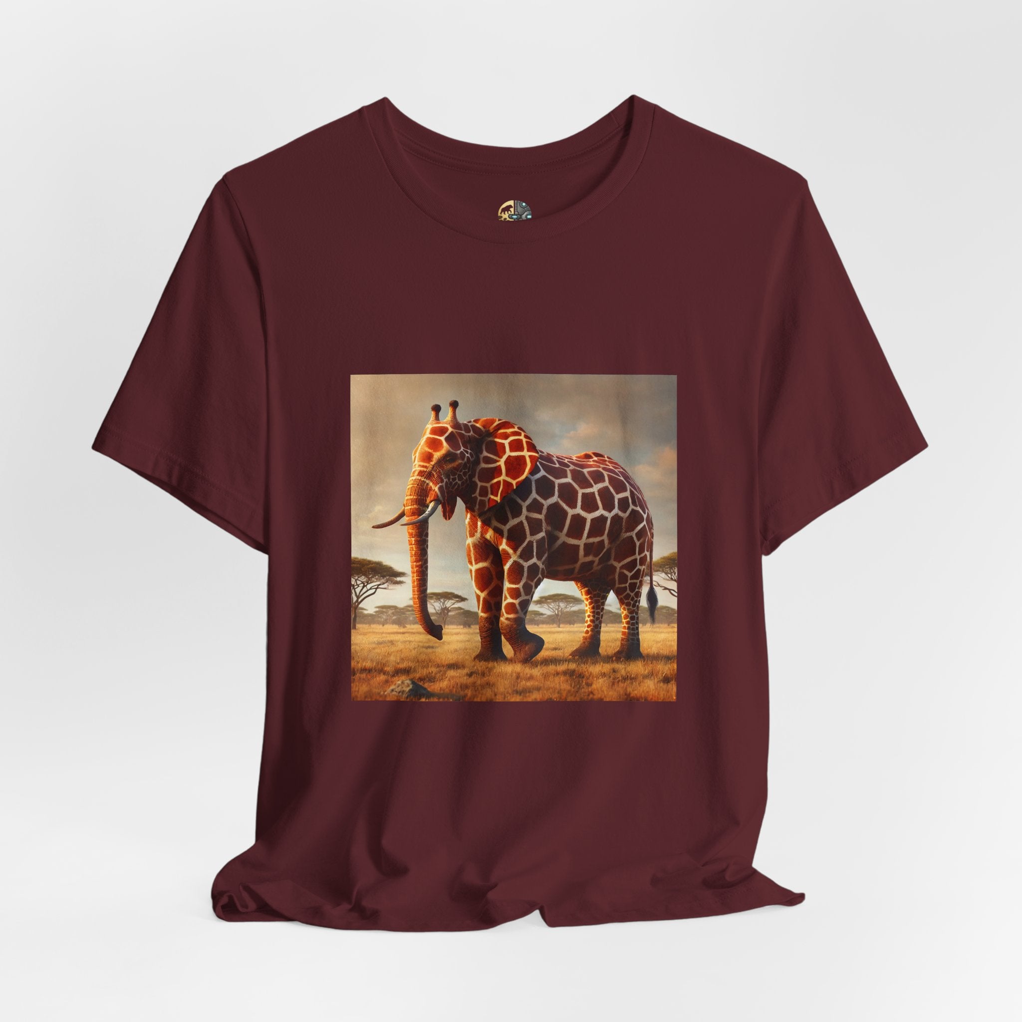 Maroon color T-shirt featuring a graphic of an elephant–giraffe hybrid with giraffe patterns and small ossicones, set against a savanna background