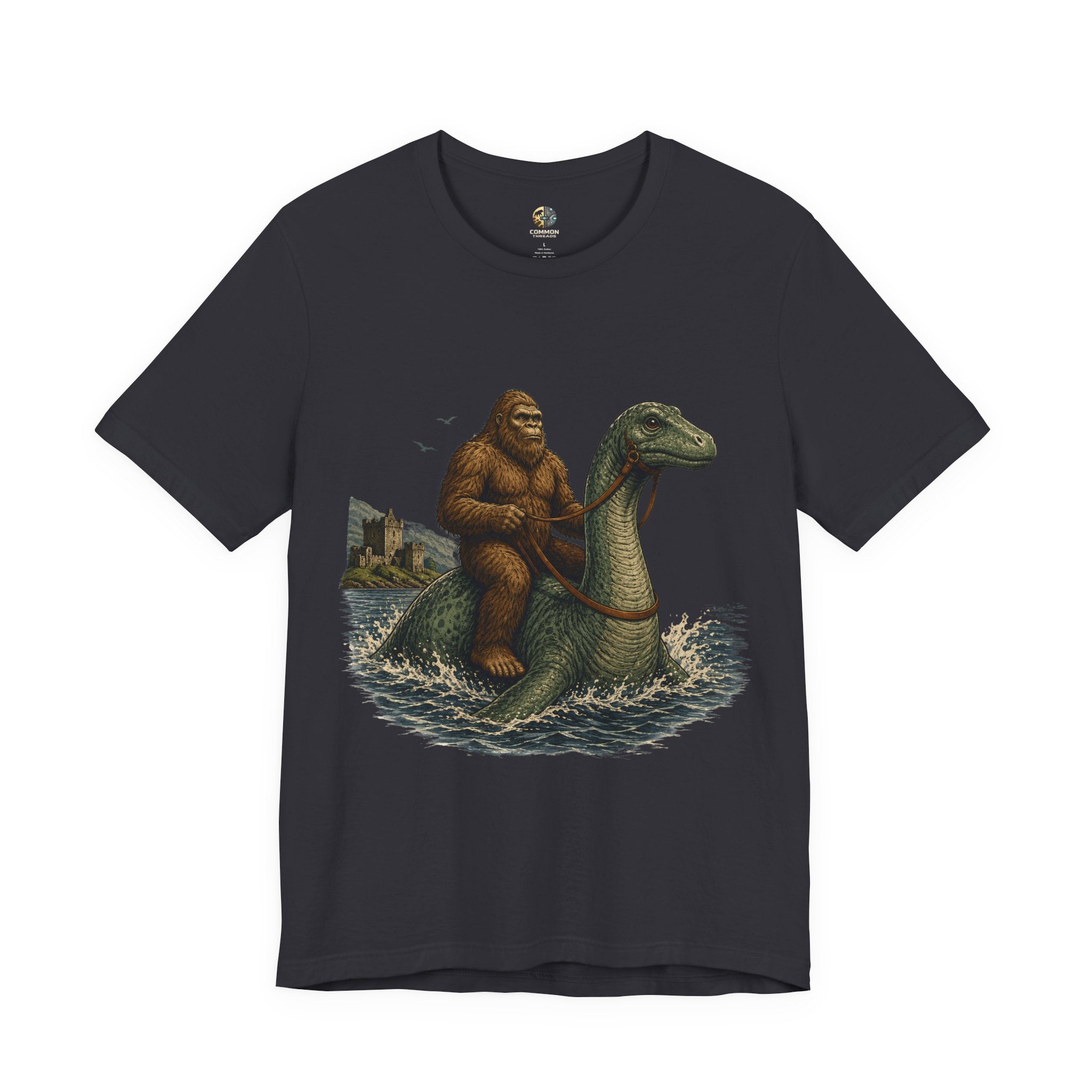 Dark grey t-shirt featuring bigfoot riding on the Loch Ness monster
