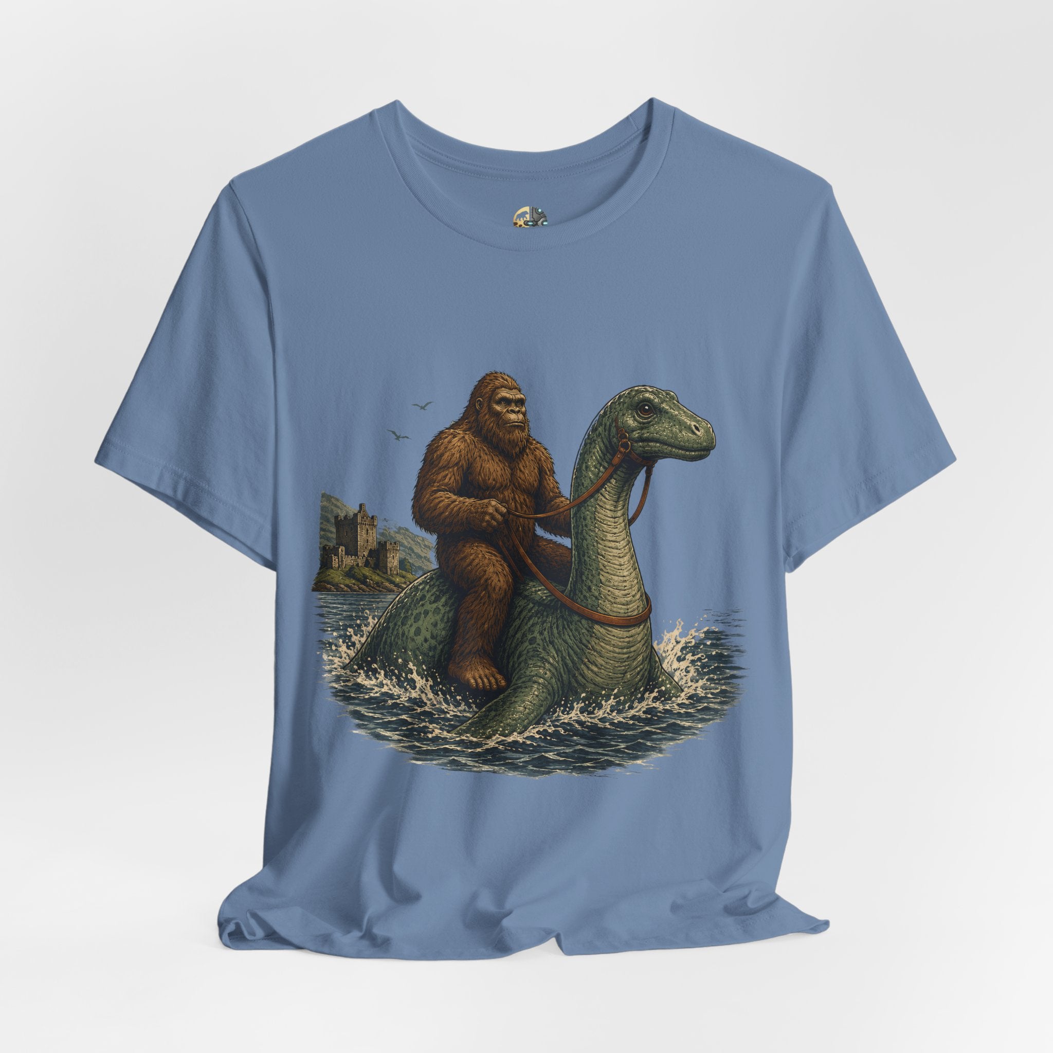Steel blue t-shirt featuring bigfoot riding on the Loch Ness monster