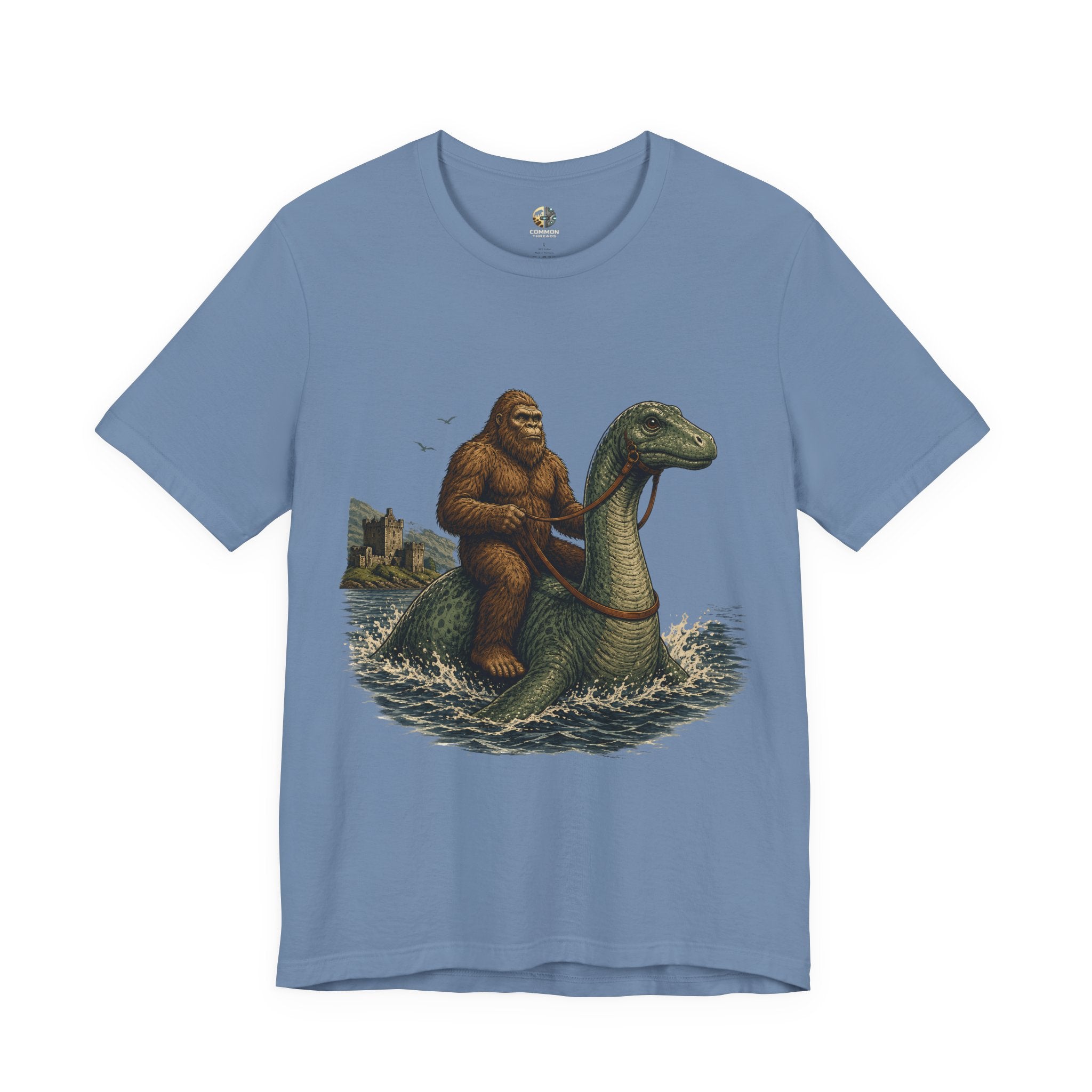 Steel blue t-shirt featuring bigfoot riding on the Loch Ness monster