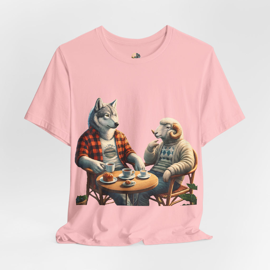Soft pink T-shirt featuring an anthropomorphic wolf in a flannel shirt and a ram in a patterned sweater sitting at a café table with coffee