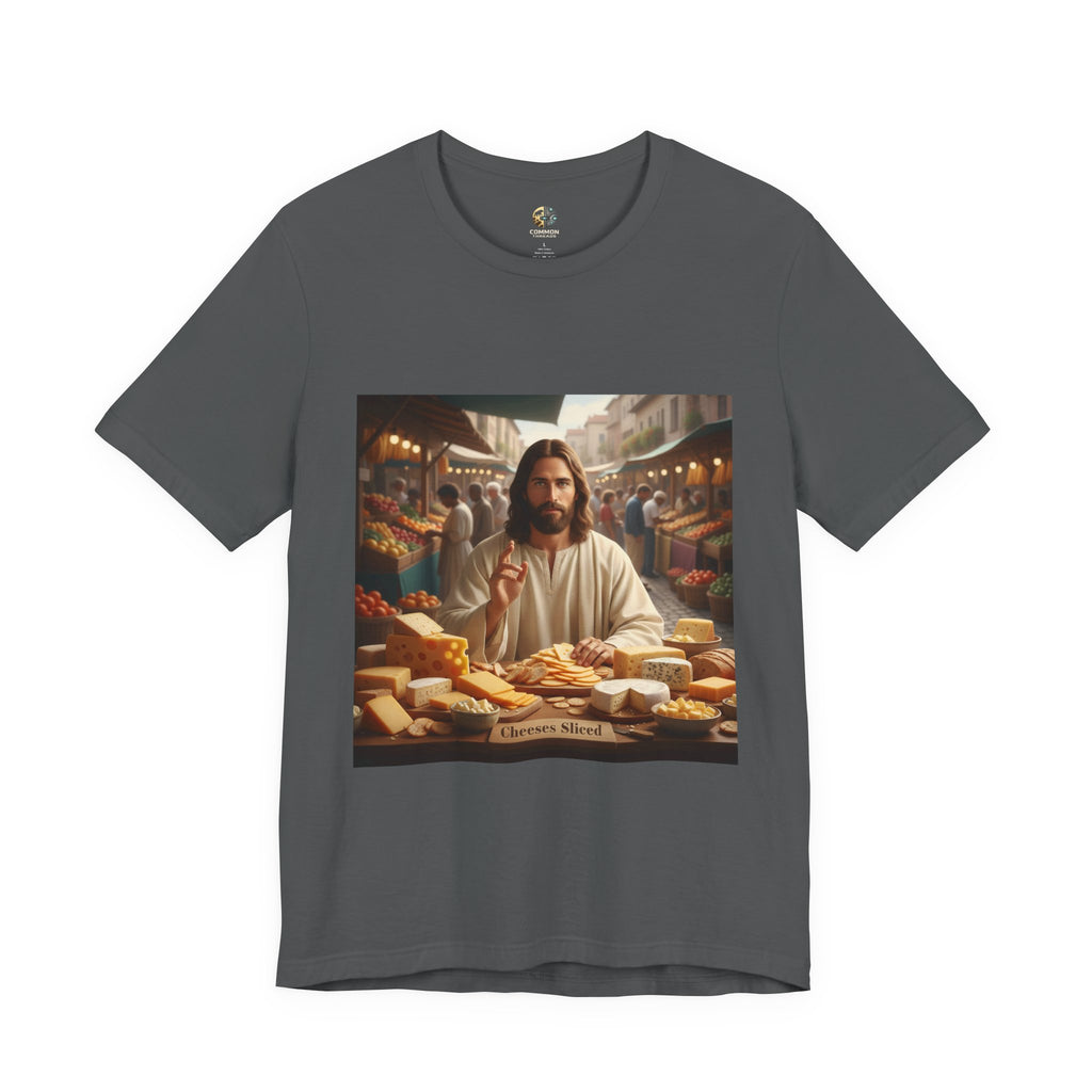 Asphalt grey T-shirt featuring a graphic of Jesus in traditional robes at an ancient marketplace selling assorted cheeses, with a sign reading ‘Cheeses Sliced‘