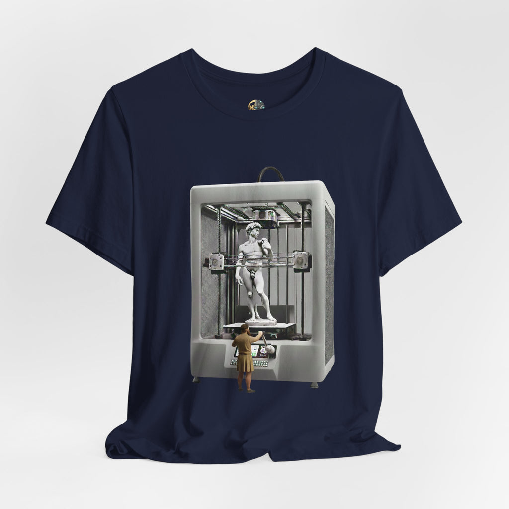 Navy blue T-shirt featuring a graphic of Michelangelo’s David statue being created inside a large 3D printer, with Michelangelo standing at the controls