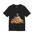 Black T-shirt featuring a graphic of Jesus in traditional robes seated before a table filled with various cheeses, referencing a ‘Cheeses Sliced’ wordplay
