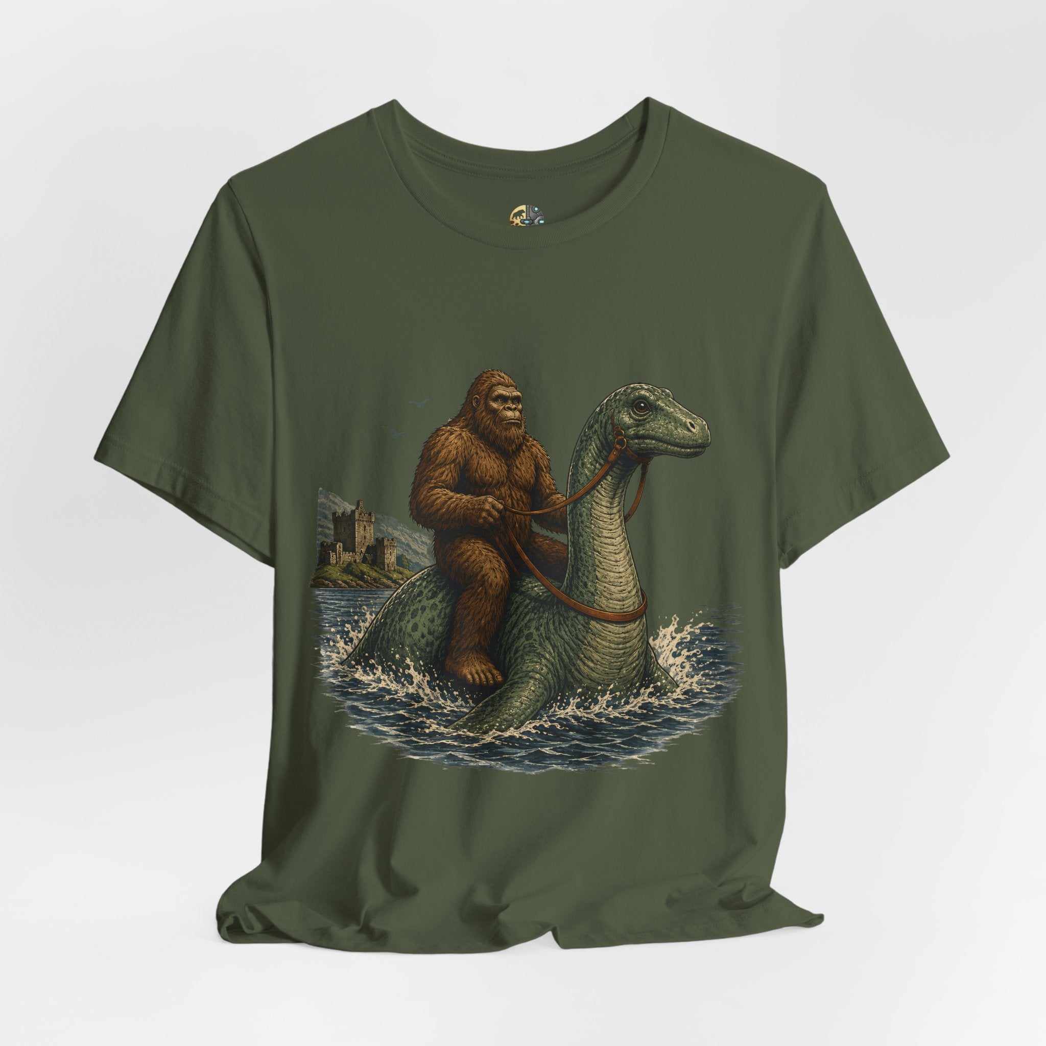 Military green t-shirt featuring bigfoot riding on the Loch Ness monster