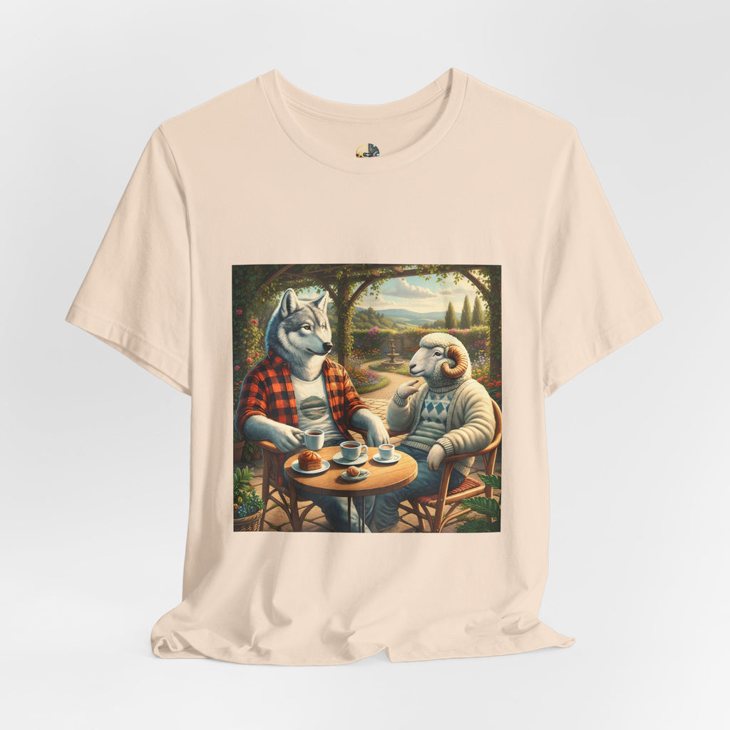 Soft creme color T-shirt featuring a graphic of a wolf in a flannel shirt and a ram in a patterned sweater sitting at a café table drinking coffee on a porch
