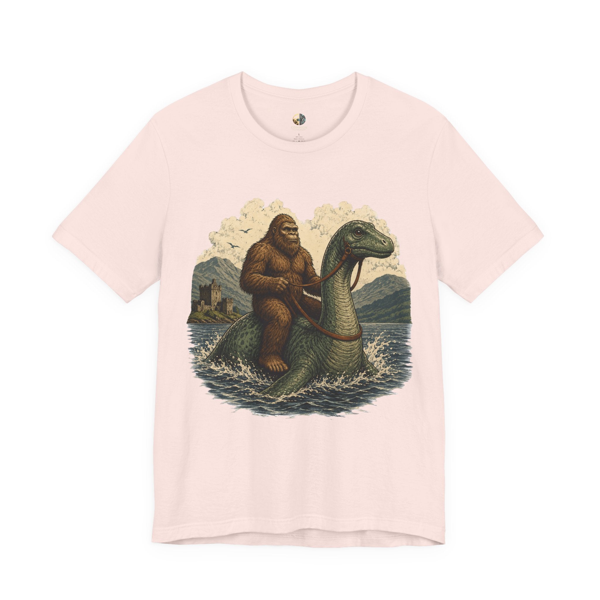 Soft pink t-shirt featuring bigfoot riding on the Loch Ness monster