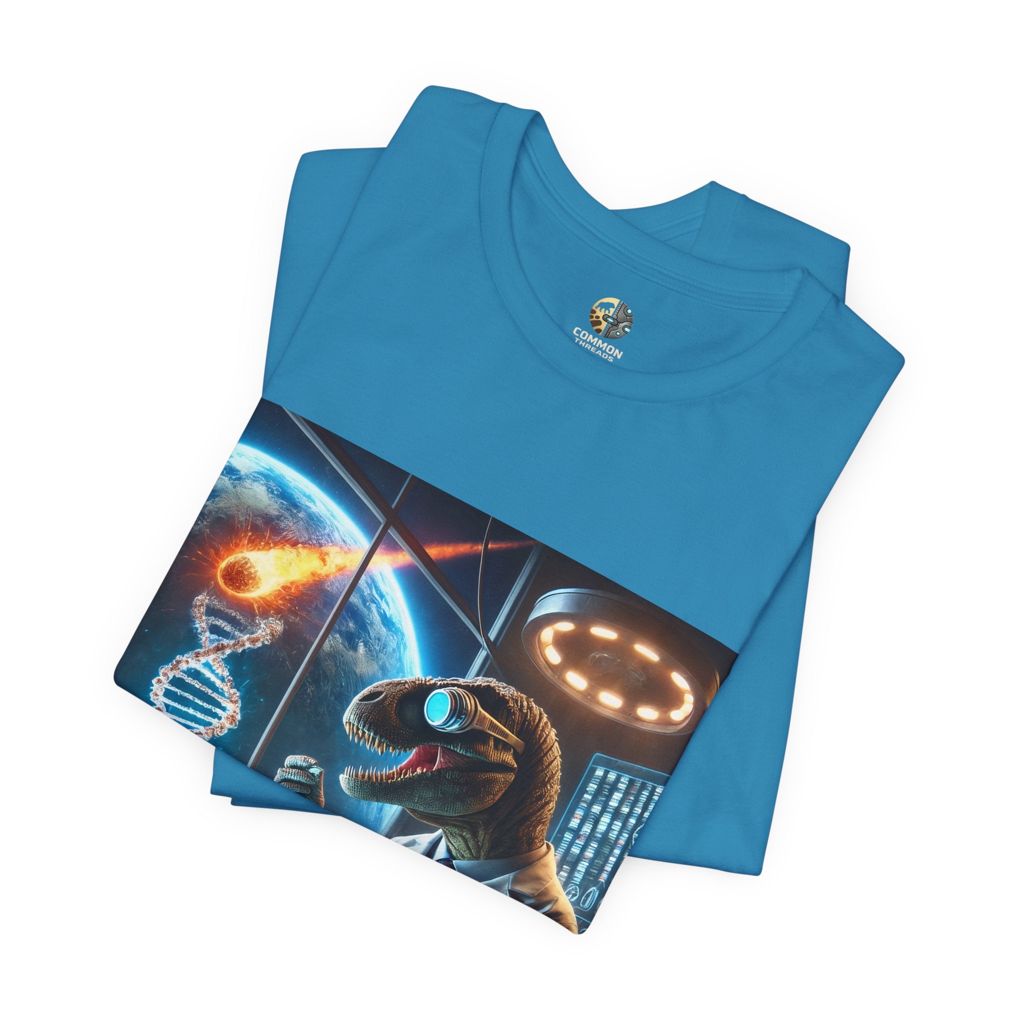 Aqua blue folded t-shirt featuring a dinosaur in a space lab conducting experiments, with Earth visible outside being hit by a meteor