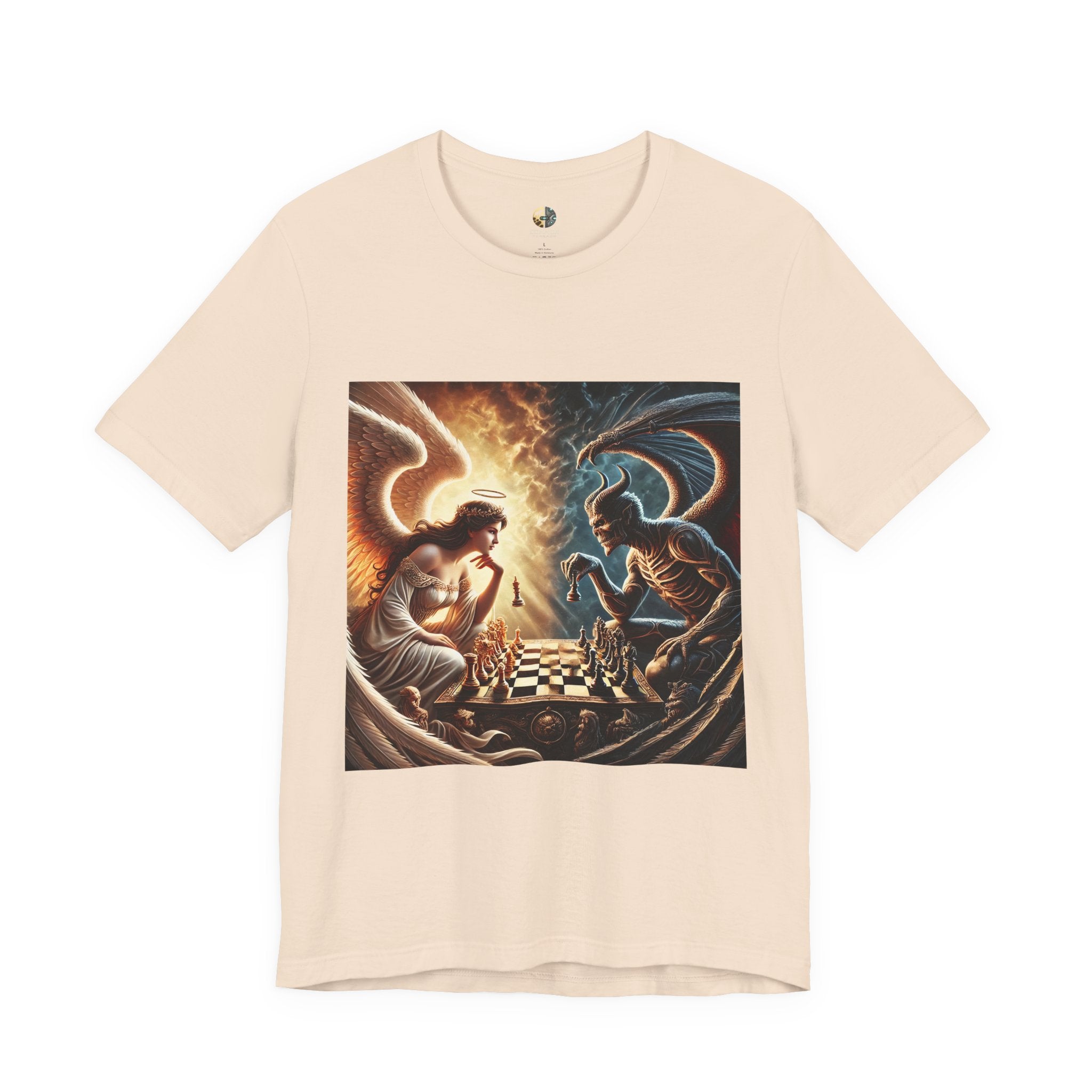 Soft creme T-shirt featuring a graphic of an angel and a demon playing chess, with a golden king piece levitating, a dark background behind the demon and warm light tones behind the angel