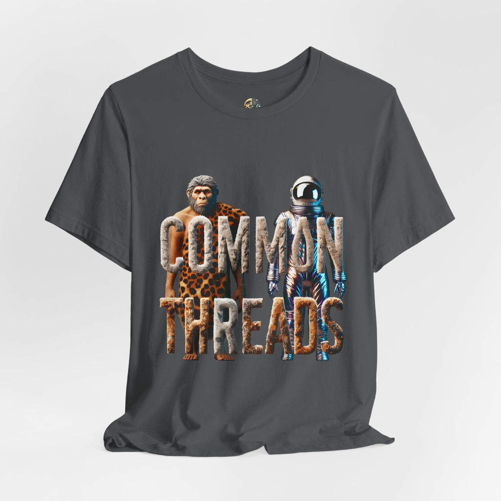 Asphalt grey T-shirt featuring a graphic of a caveman in animal pelts standing beside a chrome-plated astronaut, with the text ‘Common Threads‘