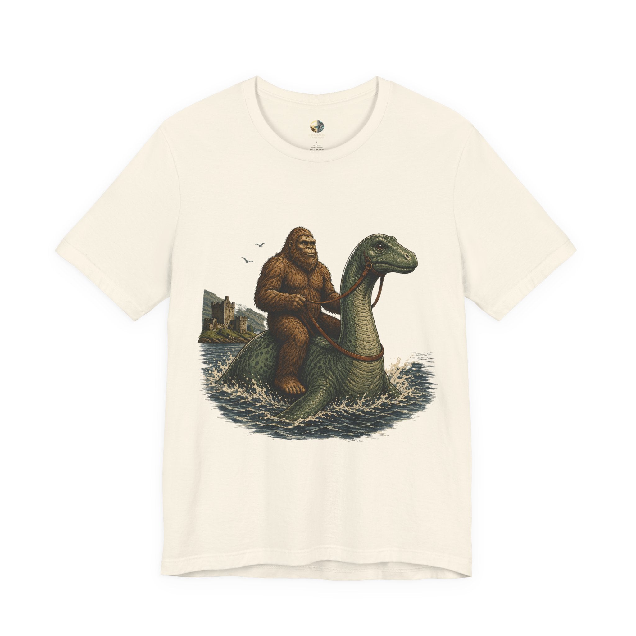 Natural color t-shirt featuring bigfoot riding on the Loch Ness monster
