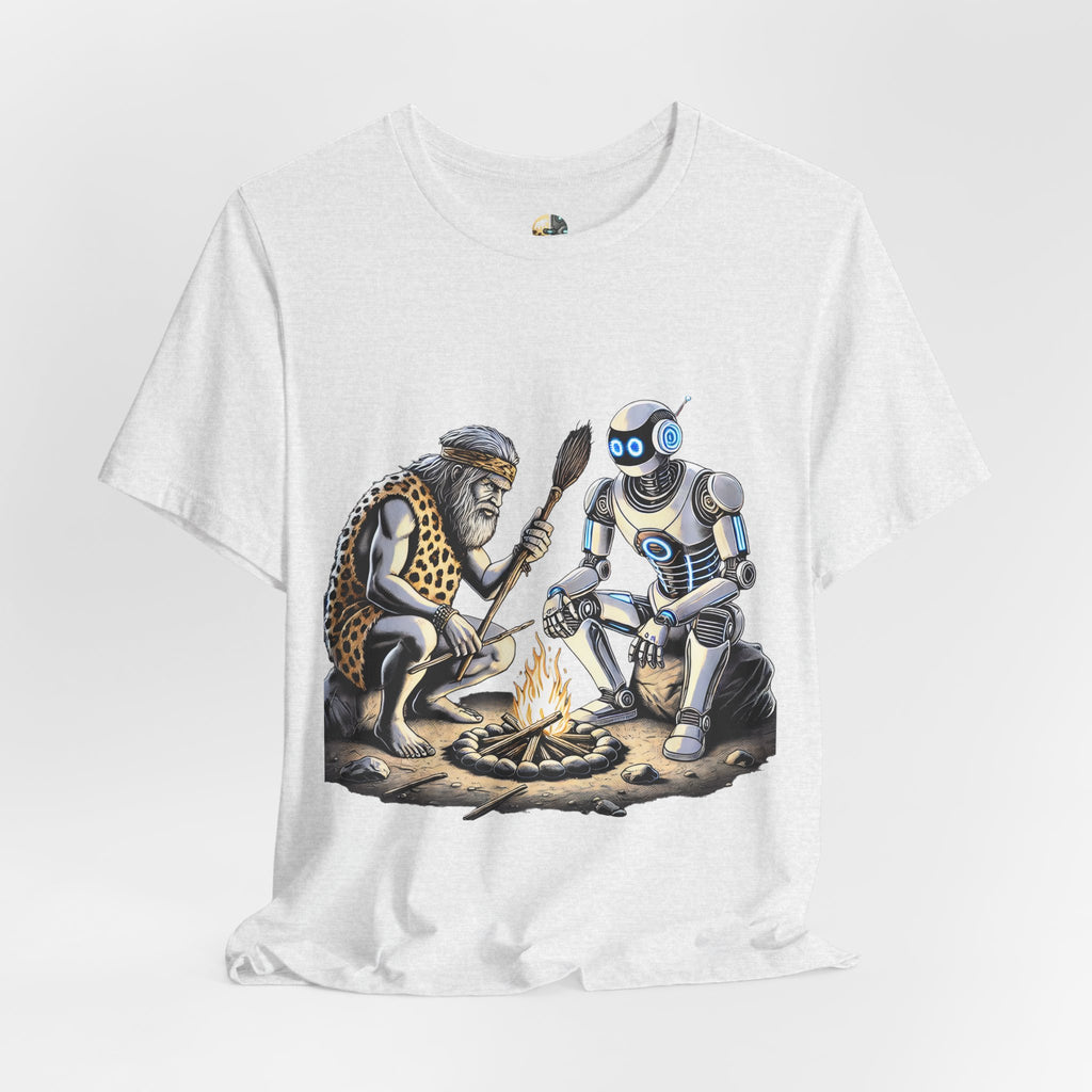 Ash color T-shirt featuring a graphic of a bearded caveman in a leopard-print pelt sitting by a campfire with a futuristic robot