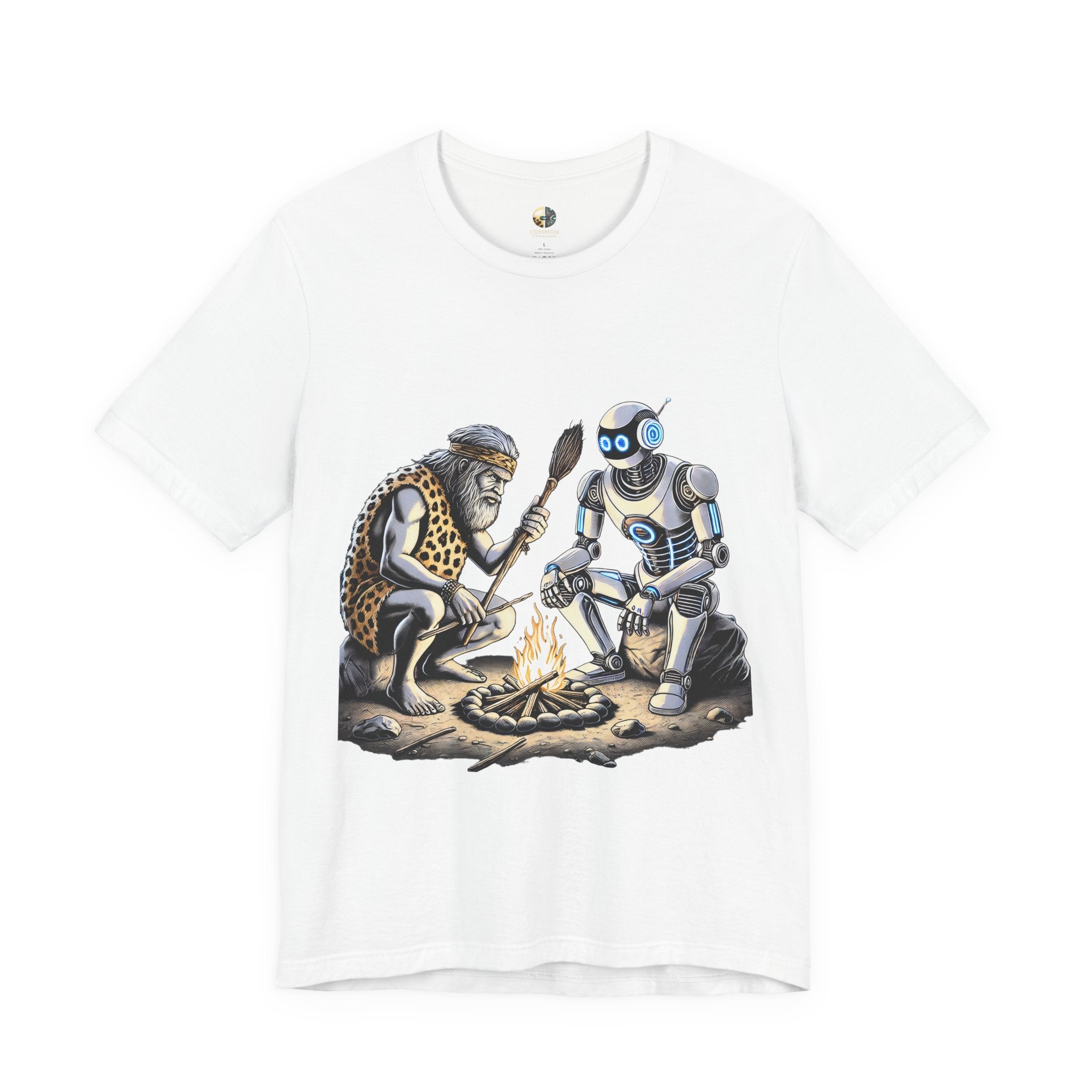 White T-shirt featuring a graphic of a bearded caveman in a leopard-print pelt sitting by a campfire with a futuristic robot