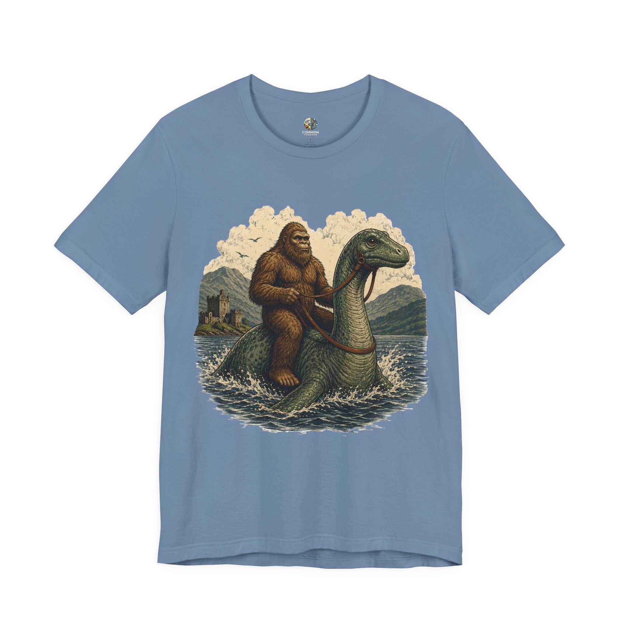 Steel blue t-shirt featuring bigfoot riding on the Loch Ness monster