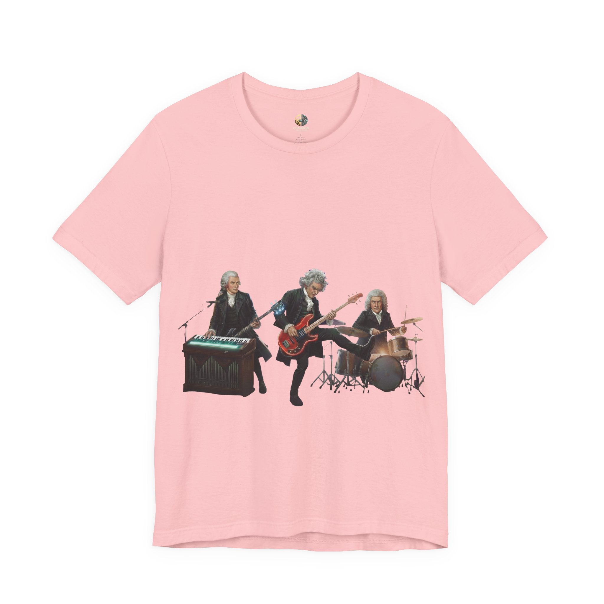 Pink t-shirt featuring Mozart on bass and keyboard, Beethoven on electric guitar, and Bach on drums in a rock band scene
