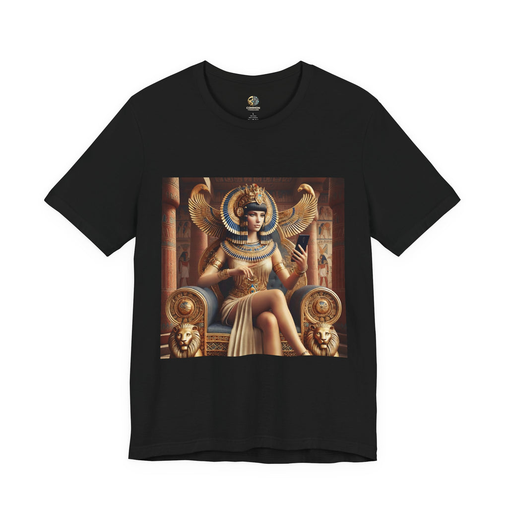 Black T-shirt featuring a graphic of Cleopatra wearing an ornate headdress and gold jewelry, seated on a throne and holding a smartphone for a selfie, with temple architecture in the background