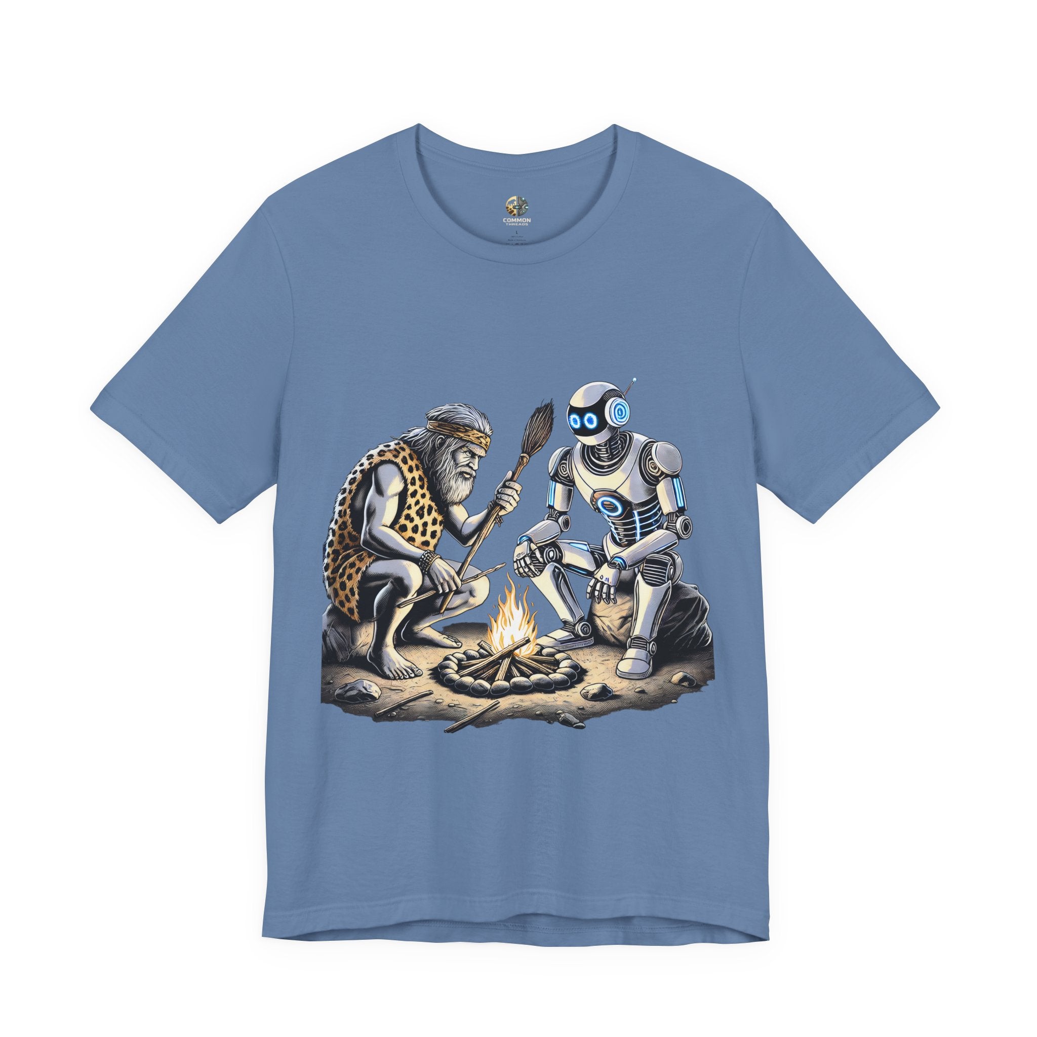 Lavender blue T-shirt featuring a graphic of a bearded caveman in a leopard-print pelt sitting by a campfire with a futuristic robot
