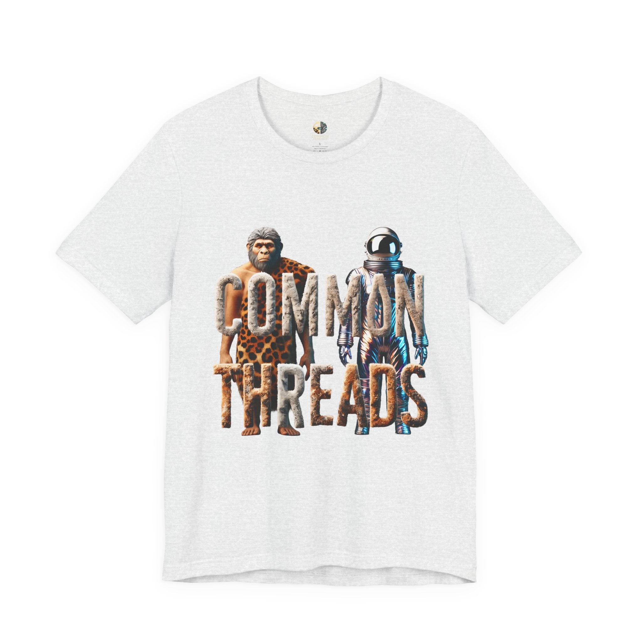 Ash color T-shirt featuring a graphic of a caveman in animal pelts standing beside a chrome-plated astronaut, with the text ‘Common Threads‘