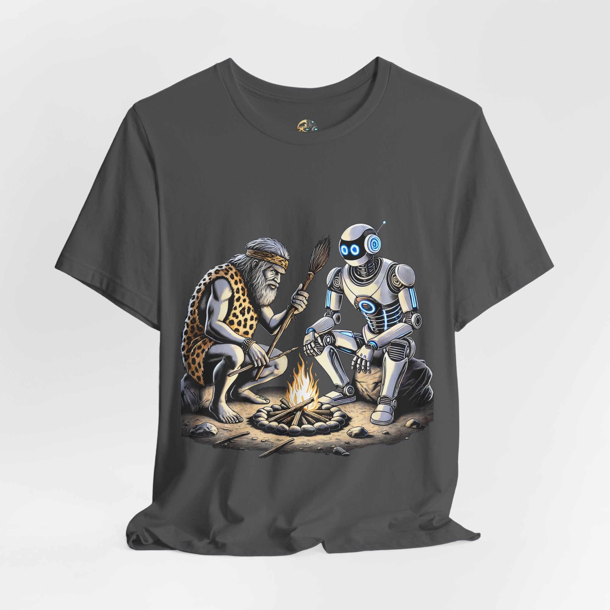 Asphalt grey T-shirt featuring a graphic of a bearded caveman in a leopard-print pelt sitting by a campfire with a futuristic robot