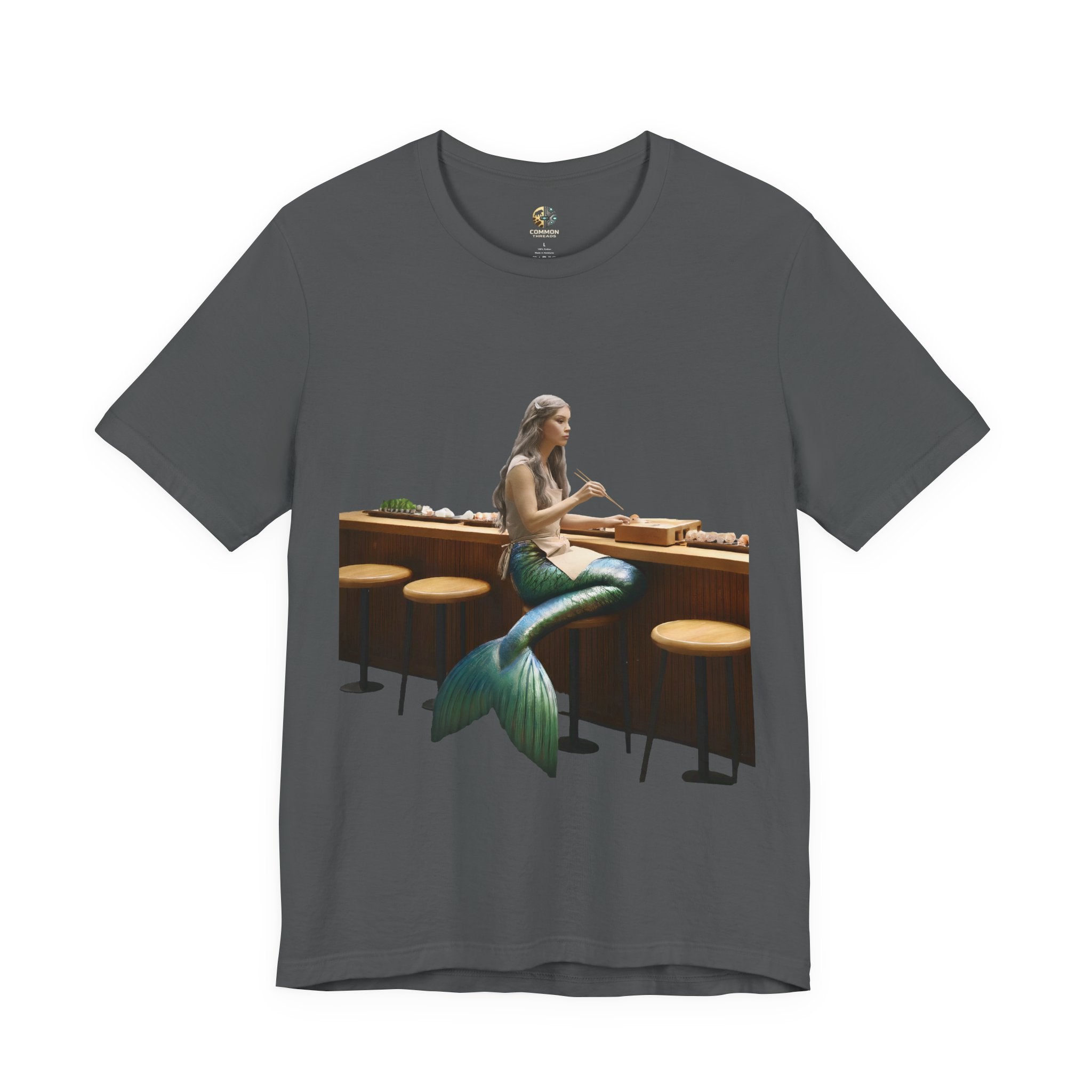 Asphalt grey T-shirt with graphic of a mermaid wearing a chef’s apron sitting at a sushi bar and eating sushi with chopsticks