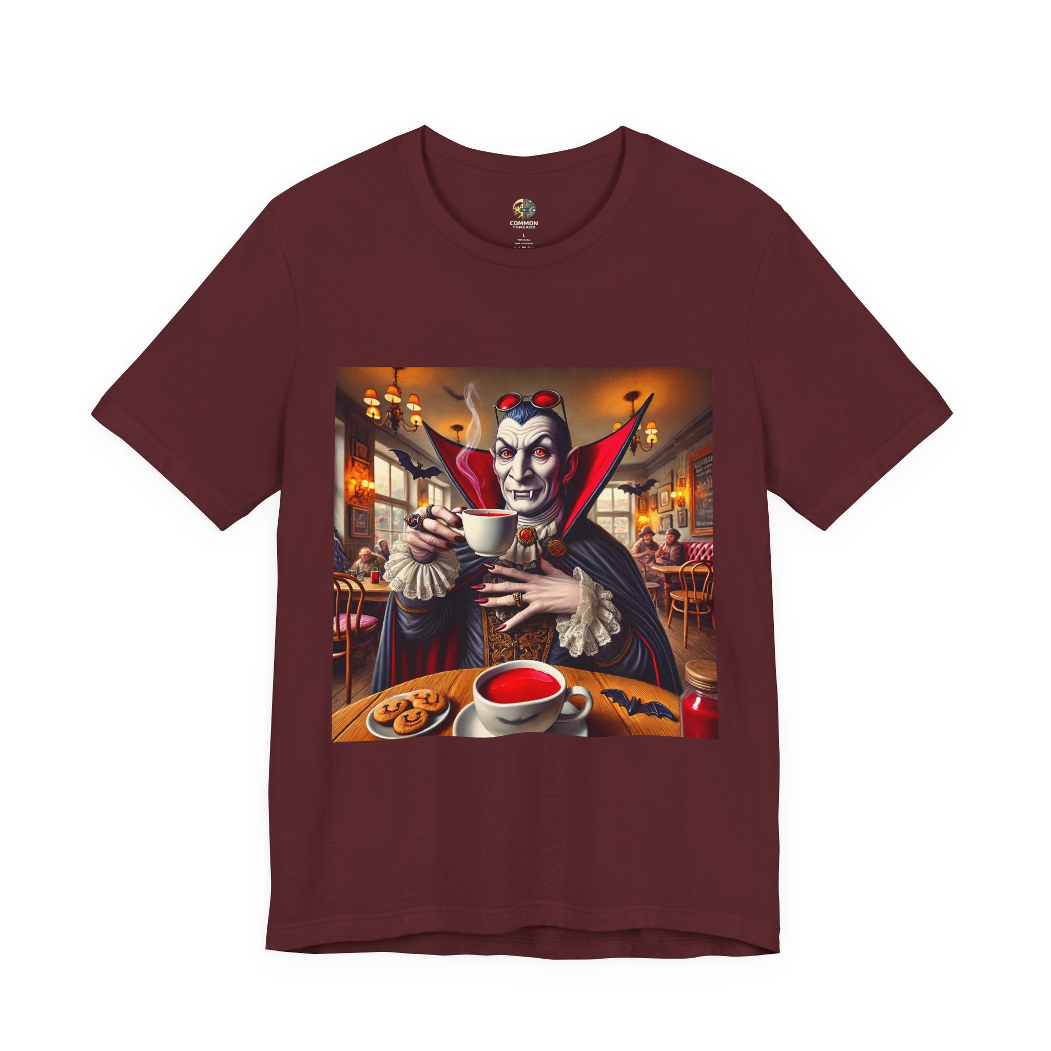 Maroon color T-shirt featuring a classic vampire dressed like Count Dracula sitting in a café, wearing red sunglasses and drinking from a teacup filled with red liquid