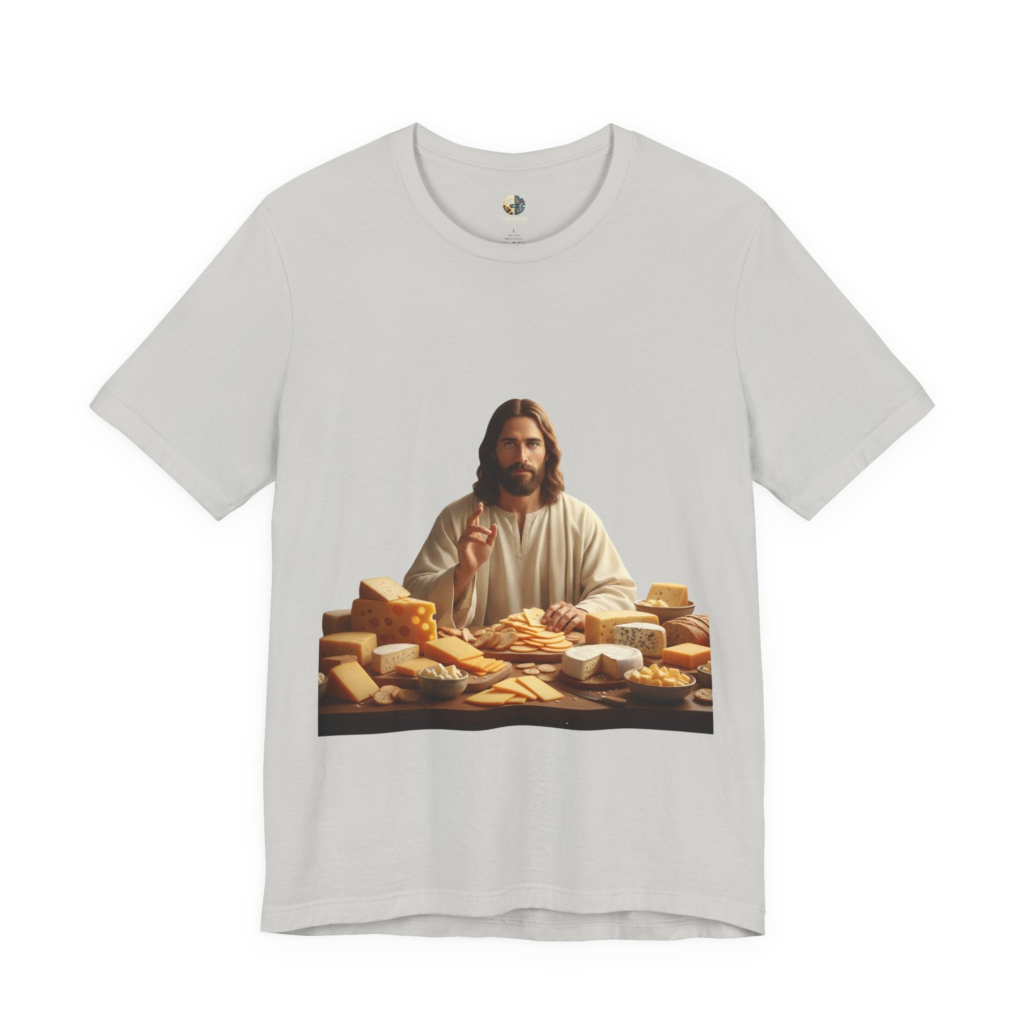 Silver T-shirt featuring a graphic of Jesus in traditional robes seated before a table filled with various cheeses, referencing a ‘Cheeses Sliced’ wordplay