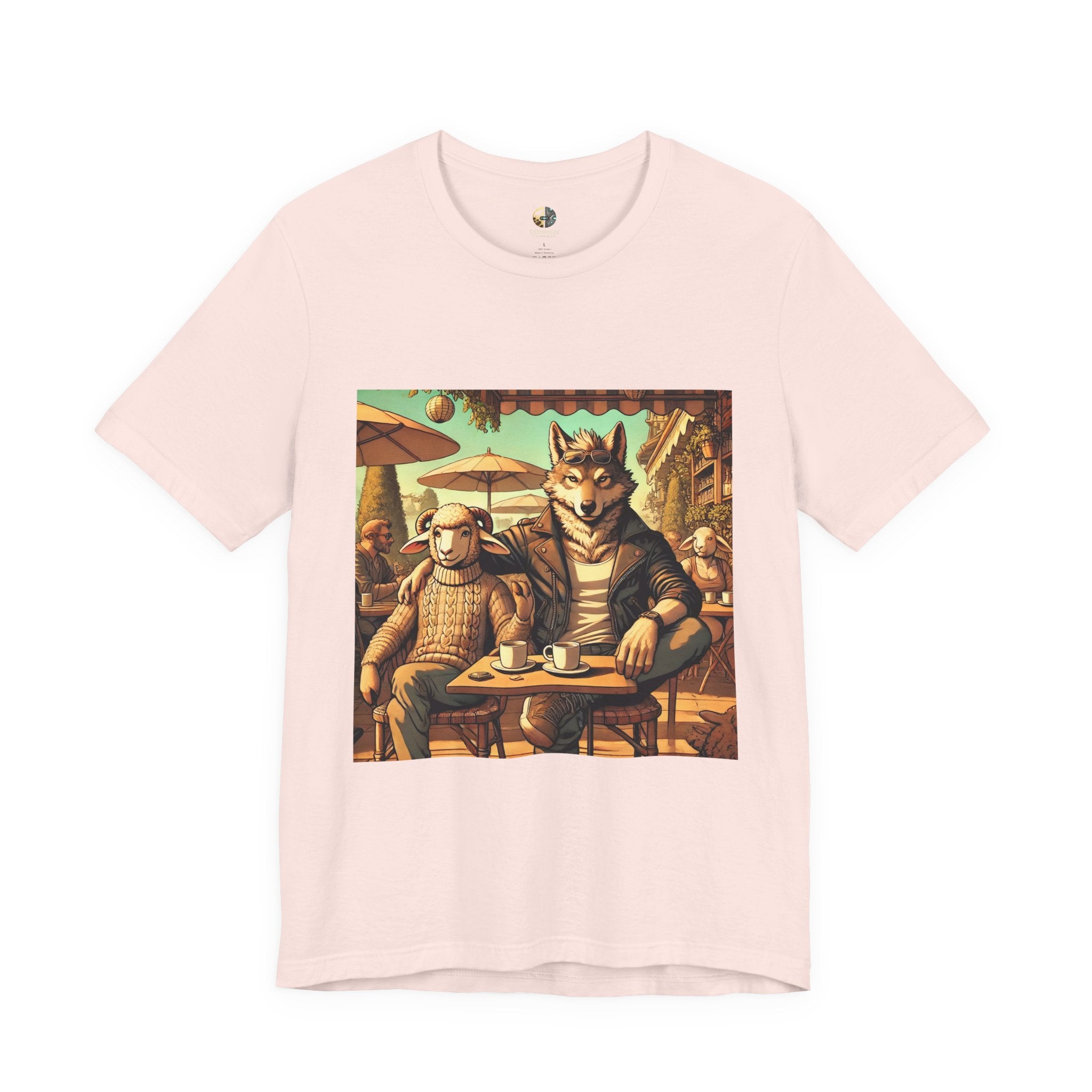Soft pink T-shirt featuring an anthropomorphic wolf and lamb seated at a café table in warm, painterly style