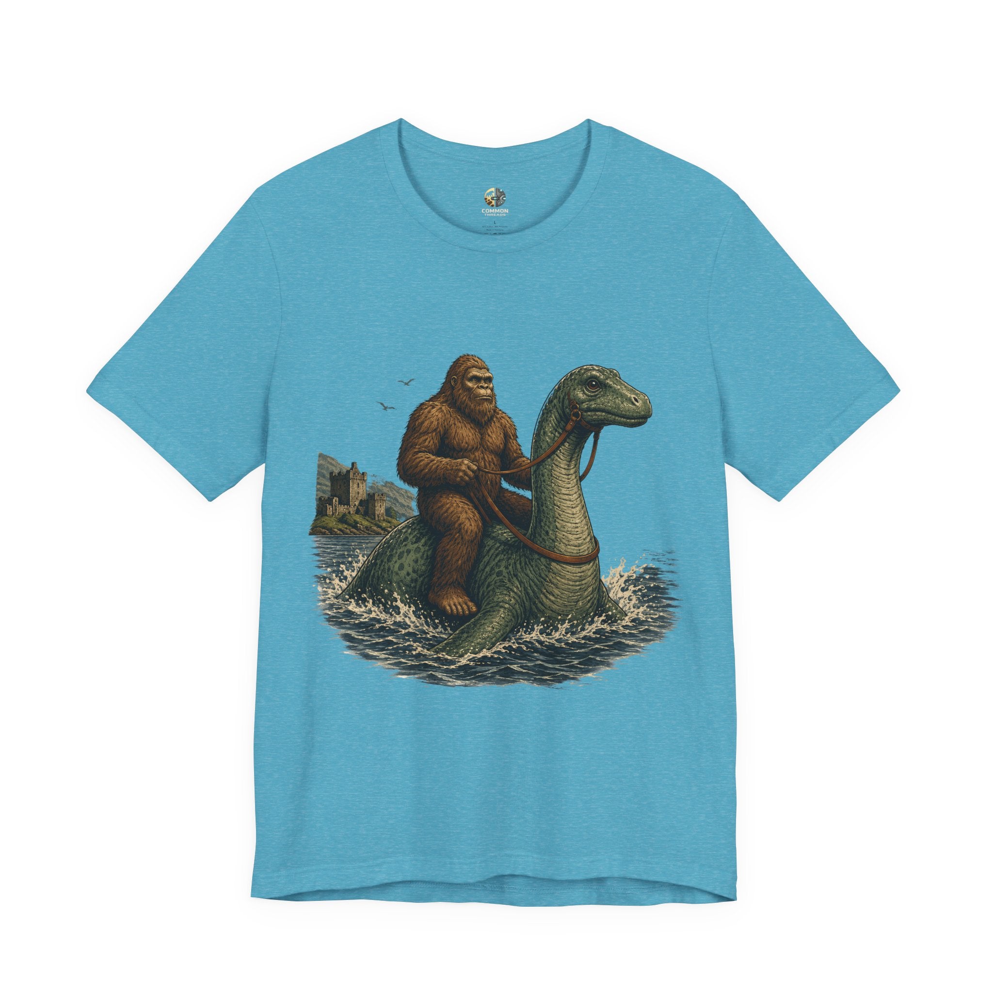 Heather aqua t-shirt featuring bigfoot riding on the Loch Ness monster