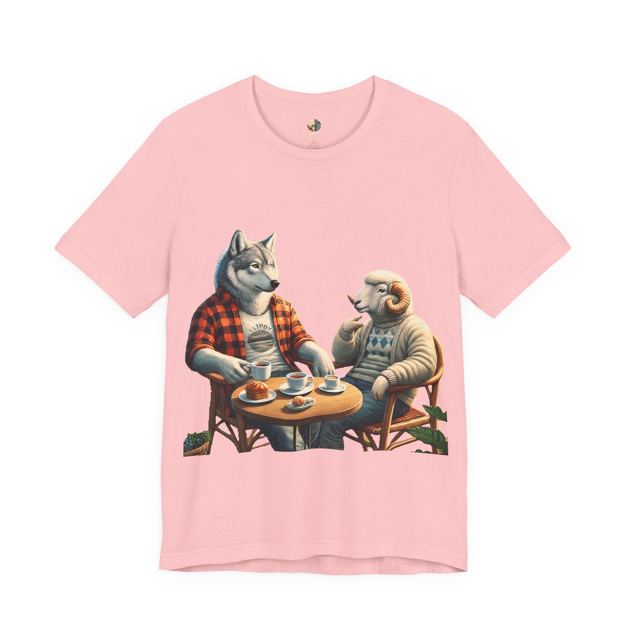 Soft pink T-shirt featuring an anthropomorphic wolf in a flannel shirt and a ram in a patterned sweater sitting at a café table with coffee