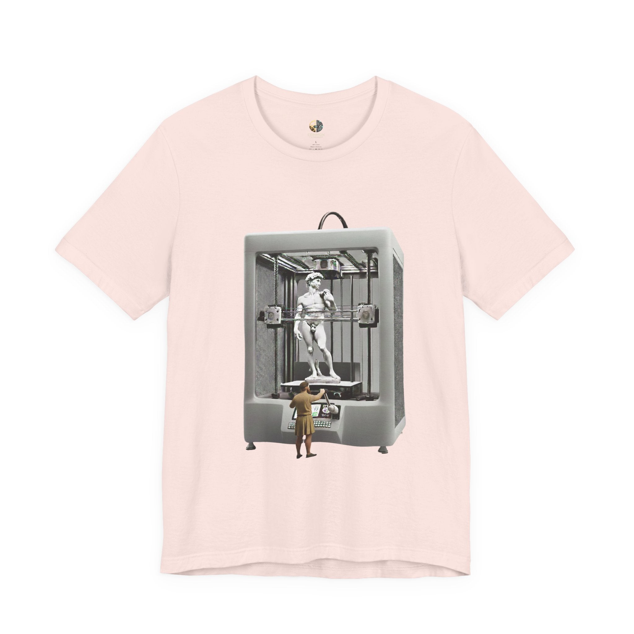 Soft pink T-shirt featuring a graphic of Michelangelo’s David statue being created inside a large 3D printer, with Michelangelo standing at the controls